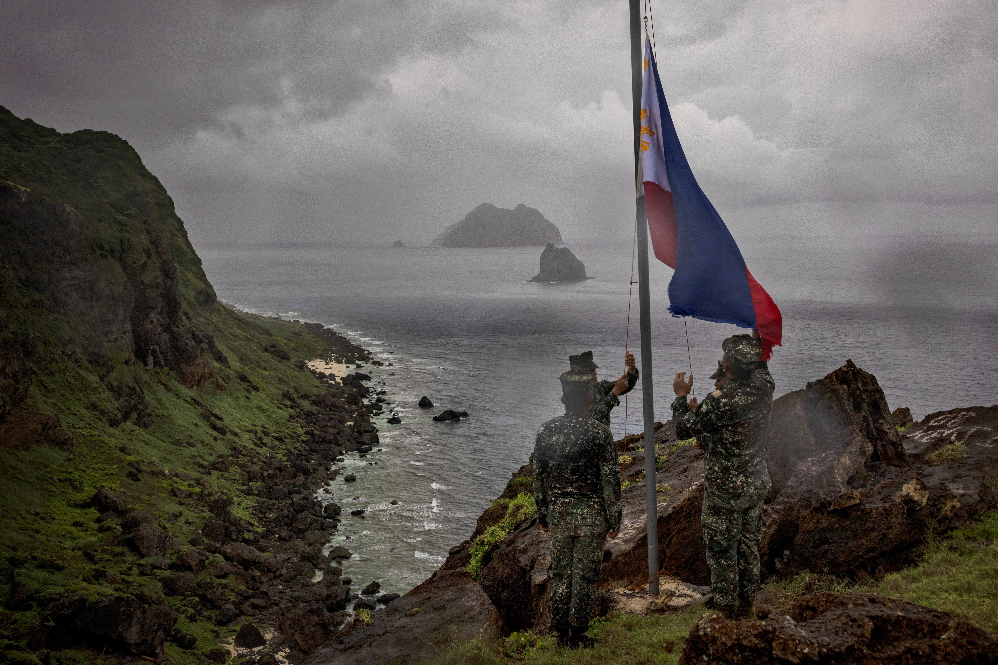 Filipino soldiers take part in a flag raising ceremony on Mavulis Island in Batanes. The channel between the Batanes islands and Taiwan is considered a choke point for vessels moving between the western Pacific and the South China Sea. Photo: Reuters