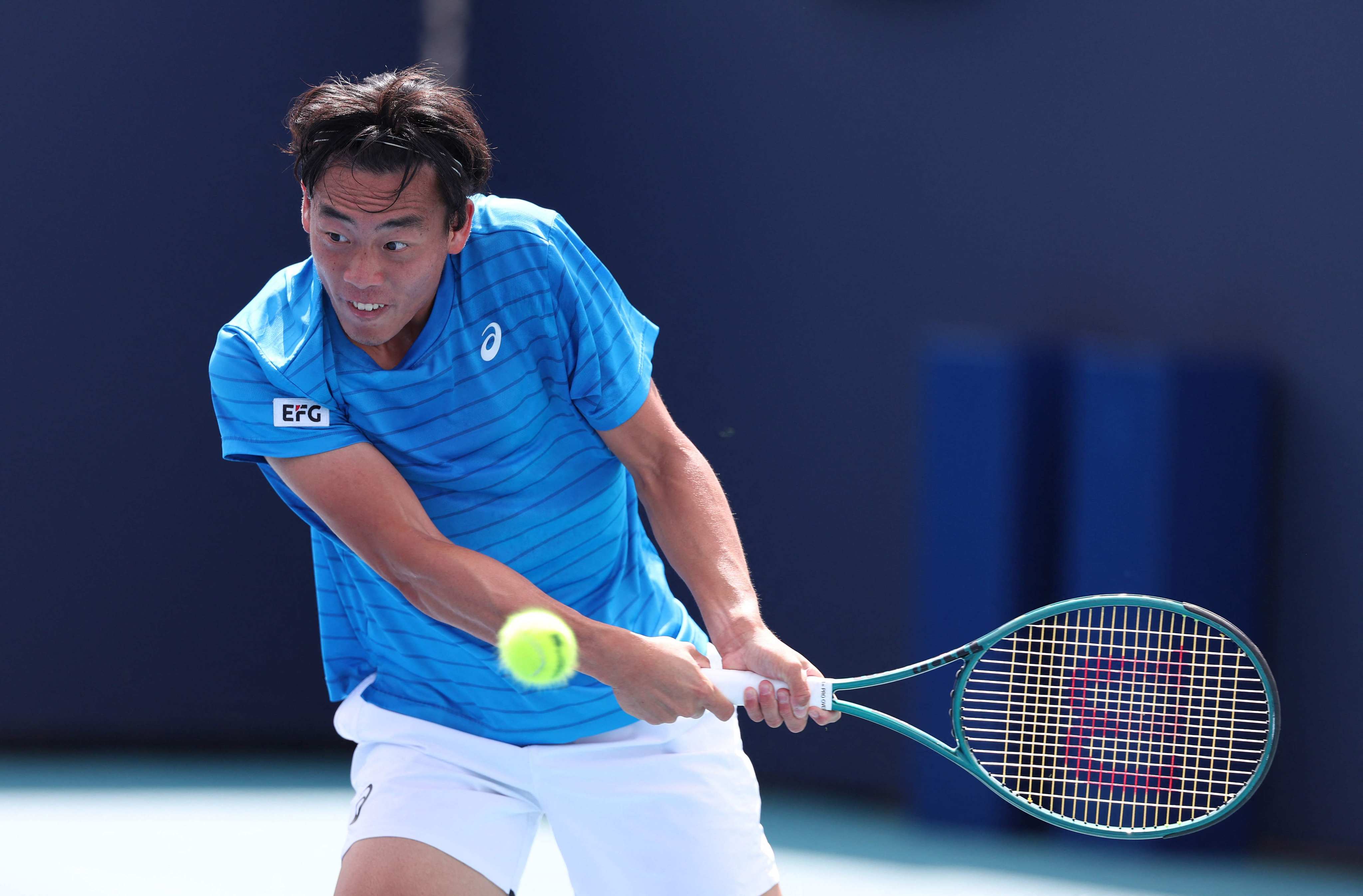 Coleman Wong returns a shot against Laslo Djere during their first round match at the Miami Open. Photo: Getty Images