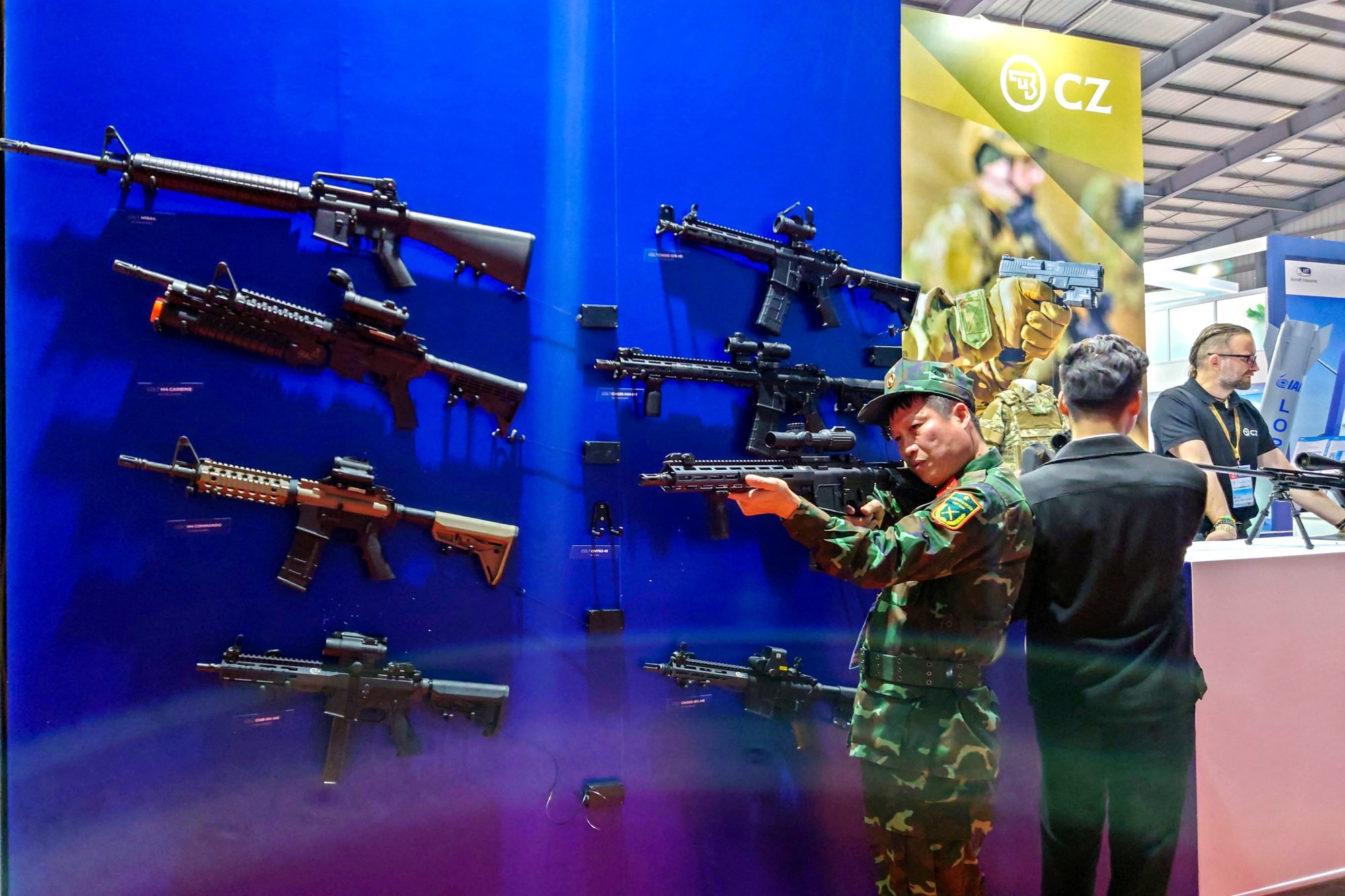 A Vietnamese officer tries a weapon at the stalls of Czech security firms at the Vietnam International Defence Expo 2022 in Hanoi. Photo: Reuters