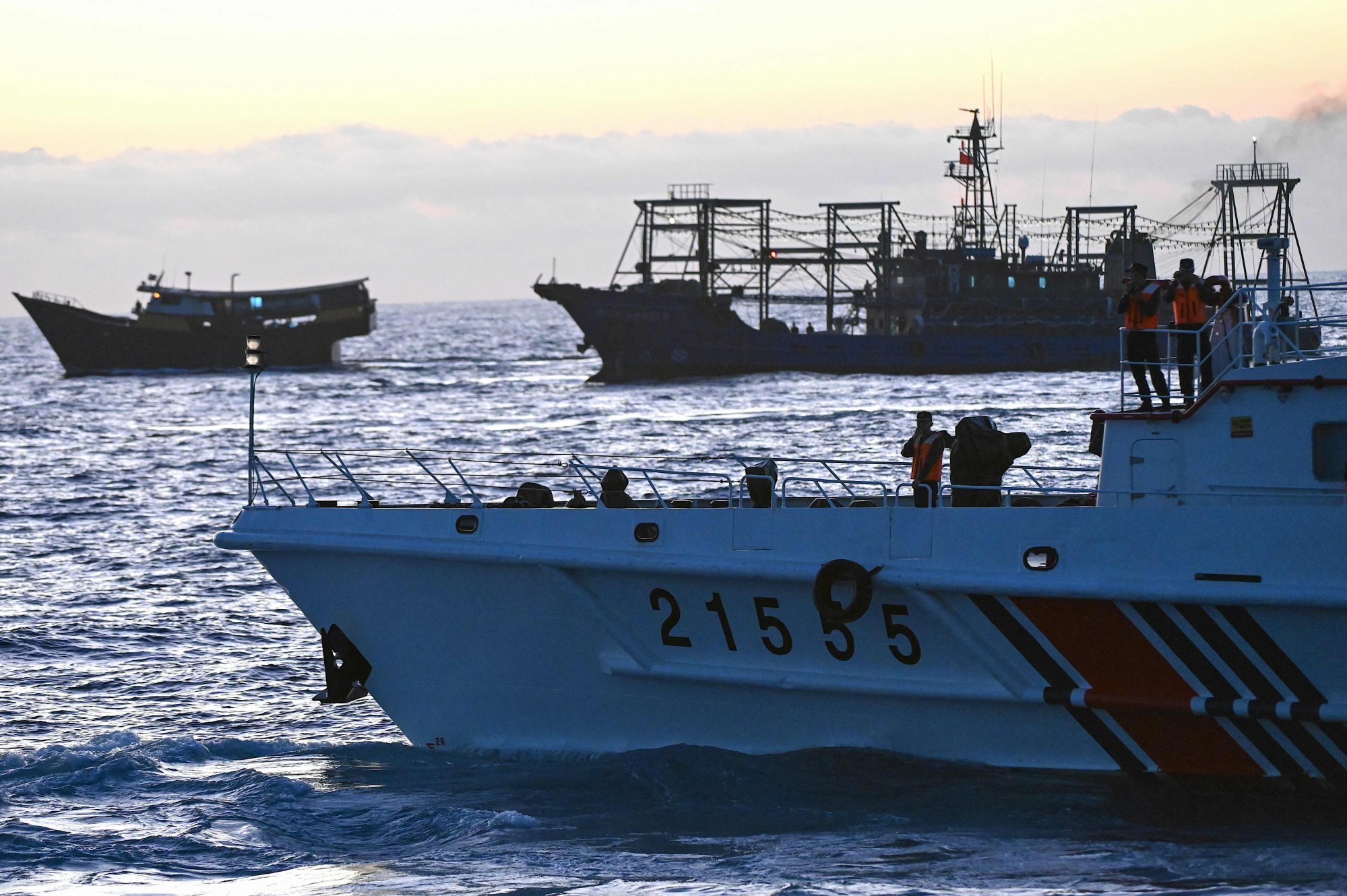 A vessel identified by the Philippine Coast Guard as “Chinese maritime militia” (top right) shadows a Philippine vessel (upper left) and a China coastguard vessel (lower right) during a supply mission to Second Thomas Shoal in the disputed South China Sea on March 5. Photo: AFP