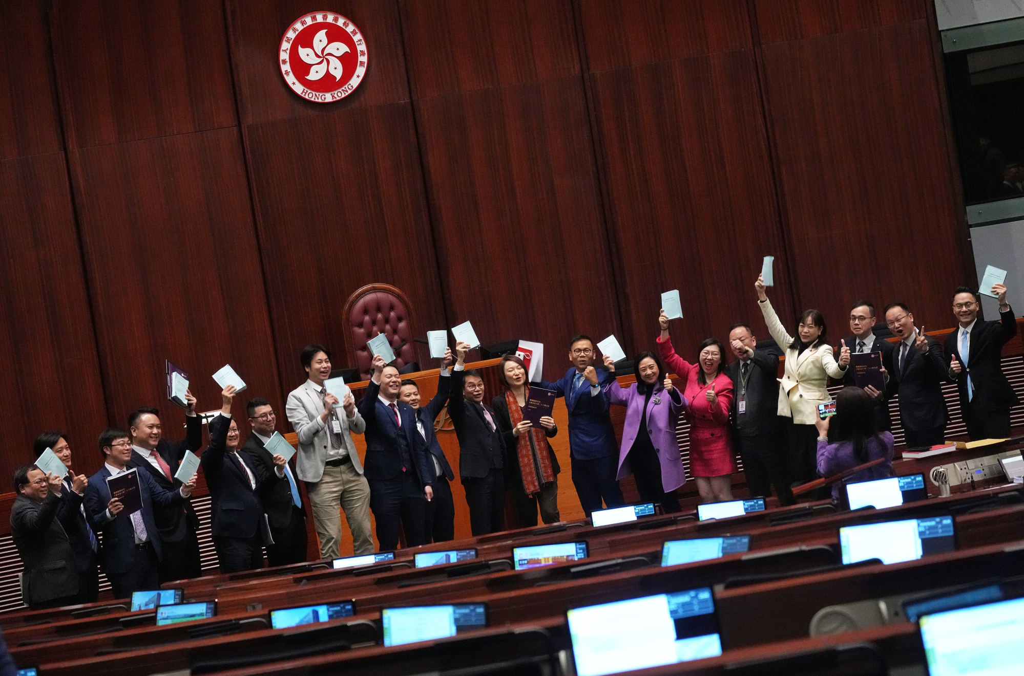 Lawmakers take pictures after the voting of the Article 23 bill in Hong Kong’s Legislative Council. Photo: Elson Li
