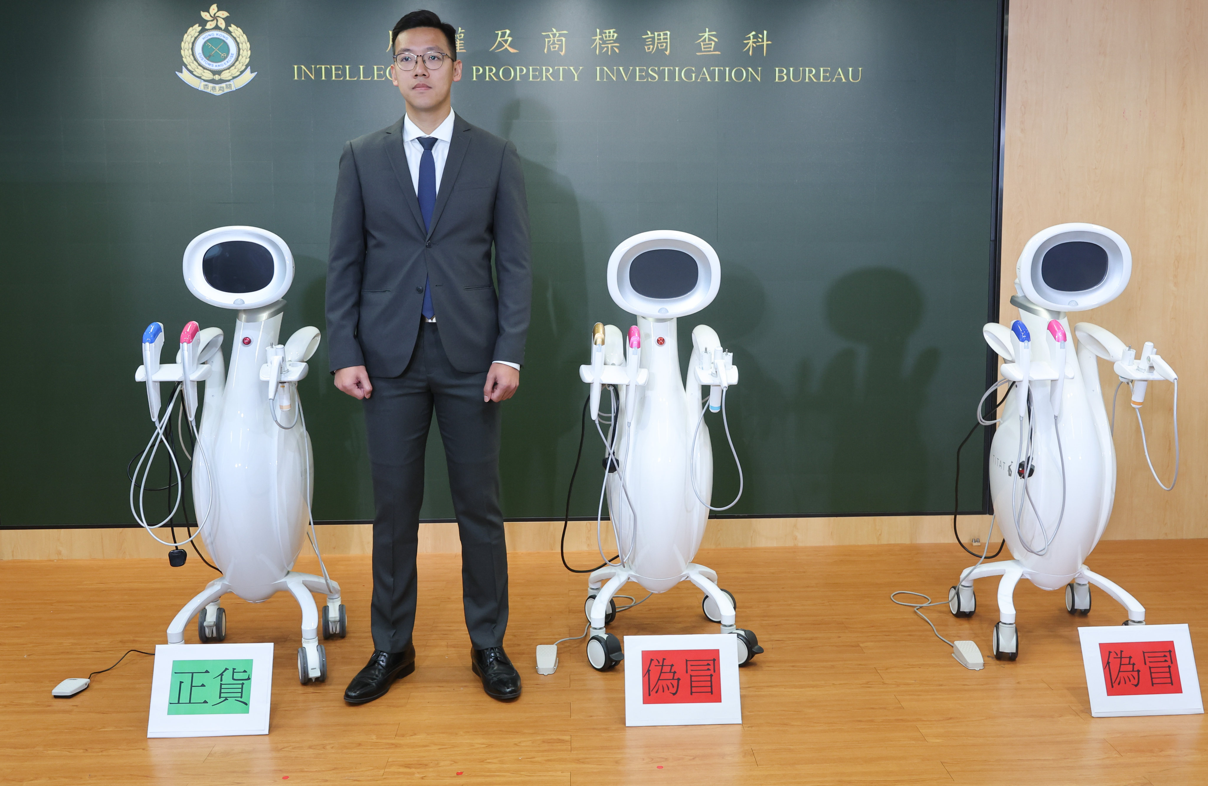 Inspector Vincent Kan of customs’ intellectual property investigation bureau with authentic and counterfeit skin treatment machines. Photo: Edmond So 