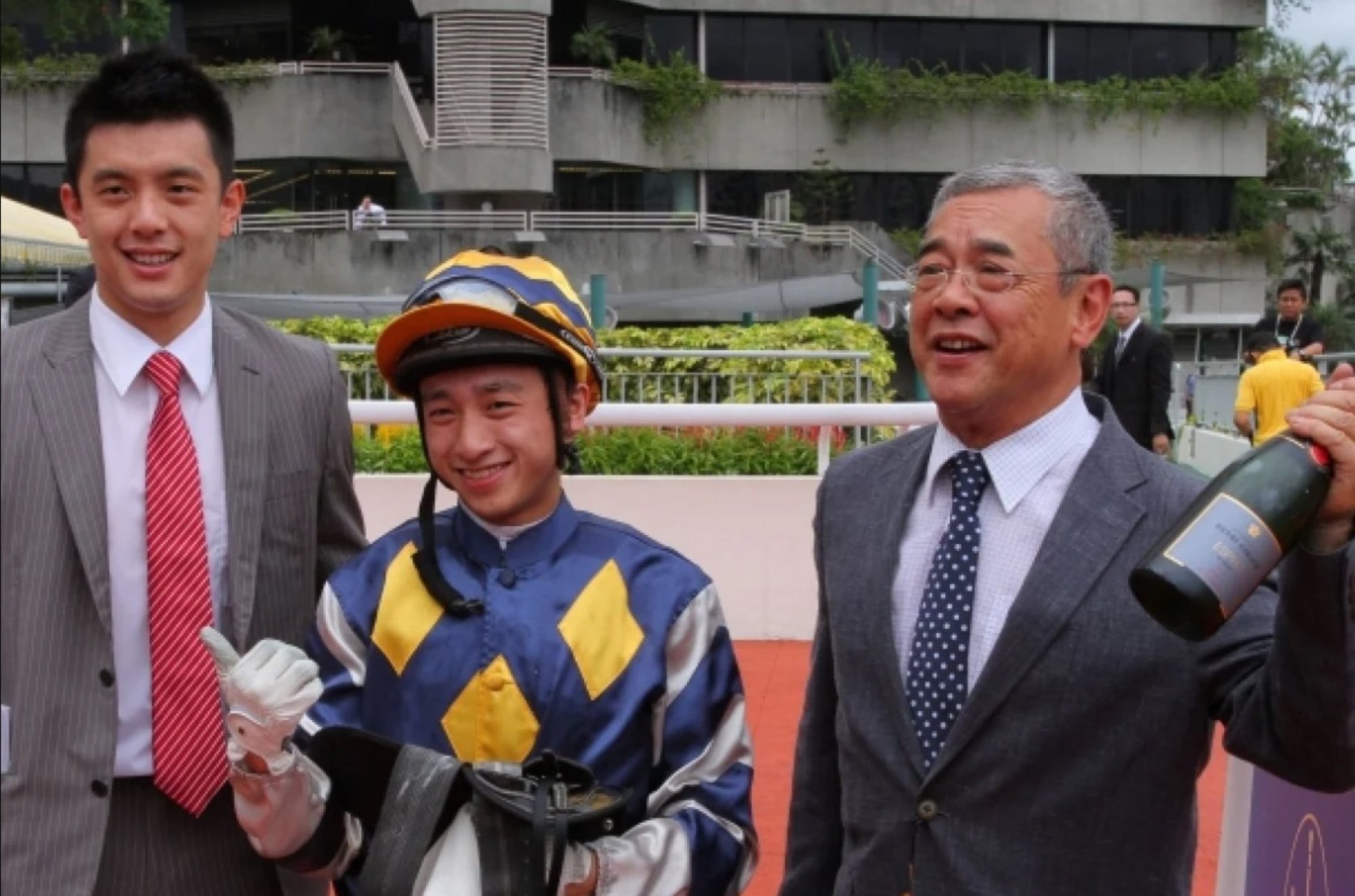 Pierre Ng (left) celebrates with his father Peter Ng and jockey Dicky Lui at Sha Tin in 2013.