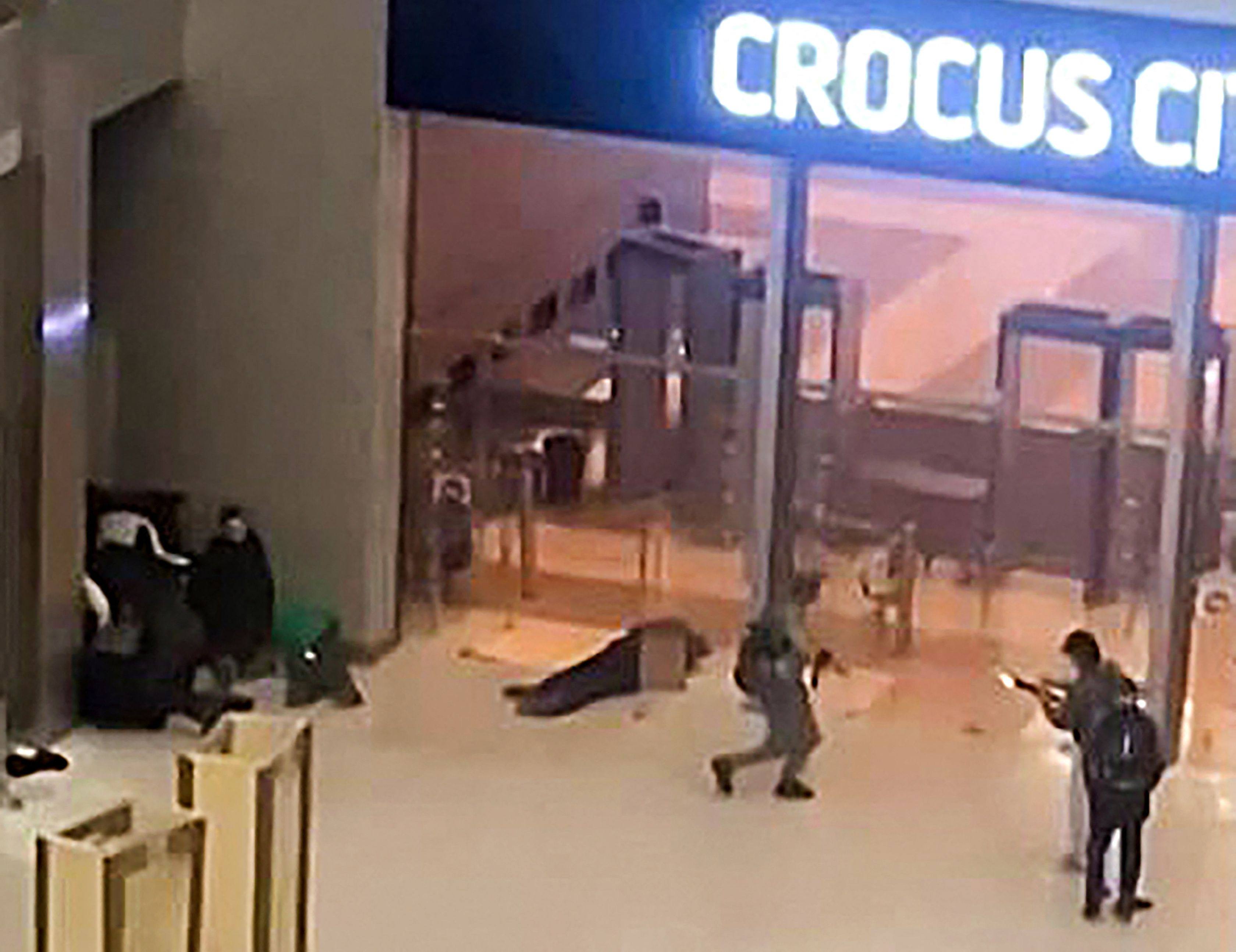 Gunmen moving towards the doors of the Crocus City Hall outside Moscow on March 22, 2024. Assailants opened fire ahead of a concert, killing more than 100. Photo: AFP 