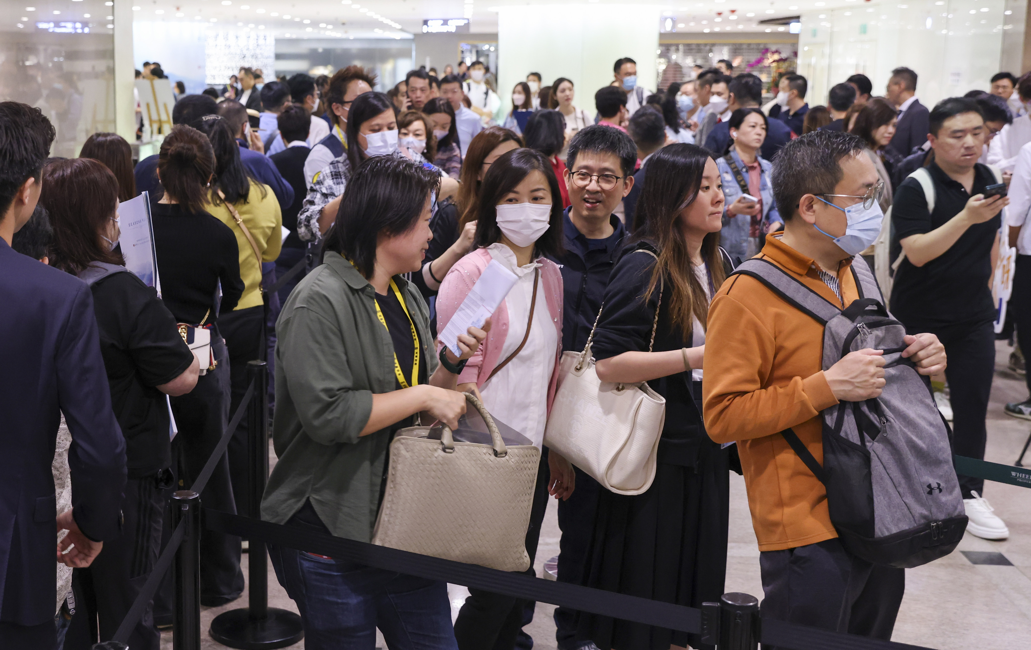 Potential home buyers line up for Wheelock Properties’ Seasons Place as it kicks off its first round of sales for 368 units on Saturday at the sales office in Tsim Sha Tsui.
Photo: SCMP / Yik Yeung-man