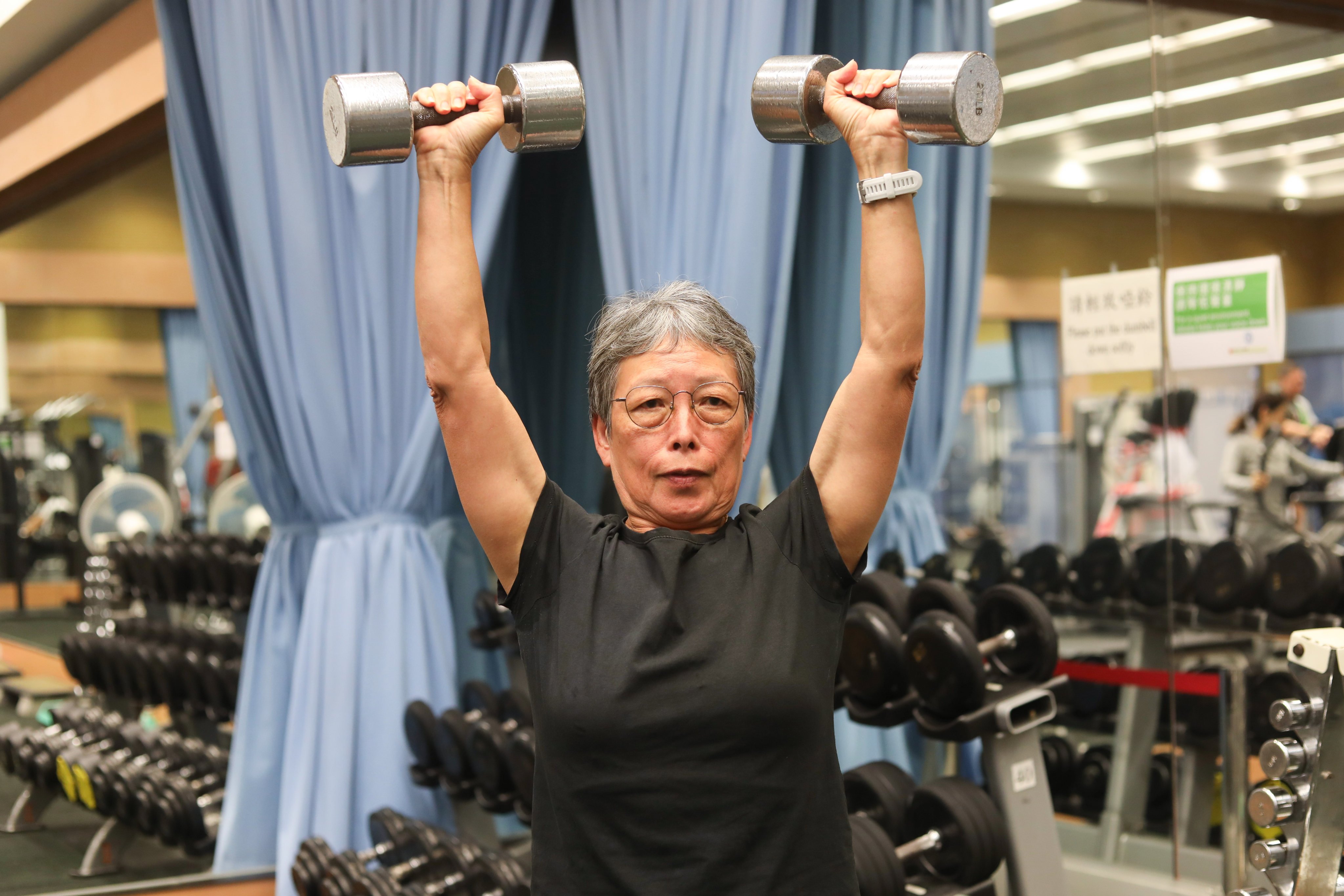 Catherine Chow, 70, lifting weights. She goes to the gym three times a week. Photo: Sun Yeung