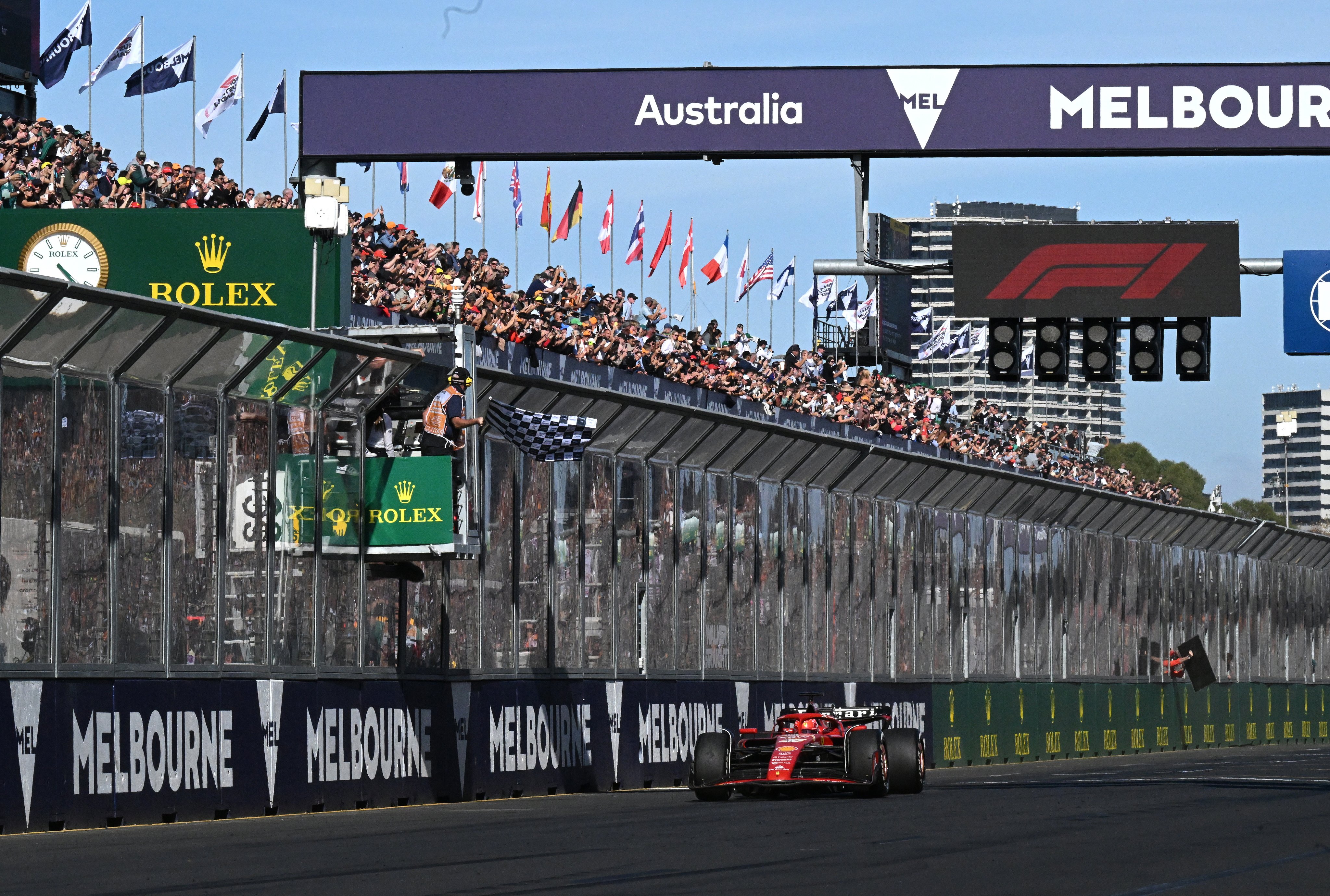 Ferrari’s Carlos Sainz takes the chequered flag to win the Australian Grand Prix at Albert Park Circuit in Melbourne. Photo: EPA-EFE