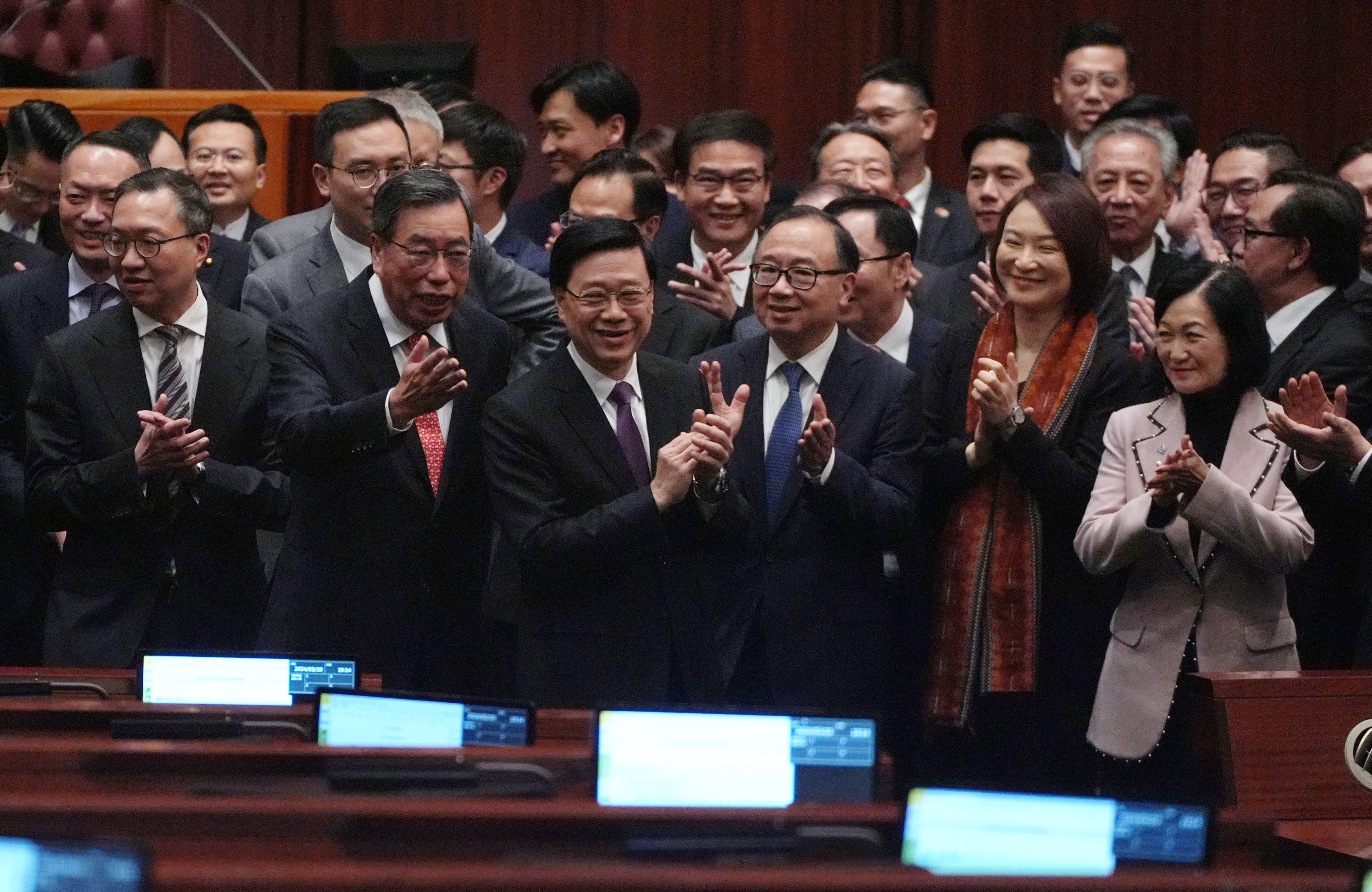 Chief Executive John Lee and legislators  celebrate as new domestic national security legislation is passed last week. Photo: Eugene Lee