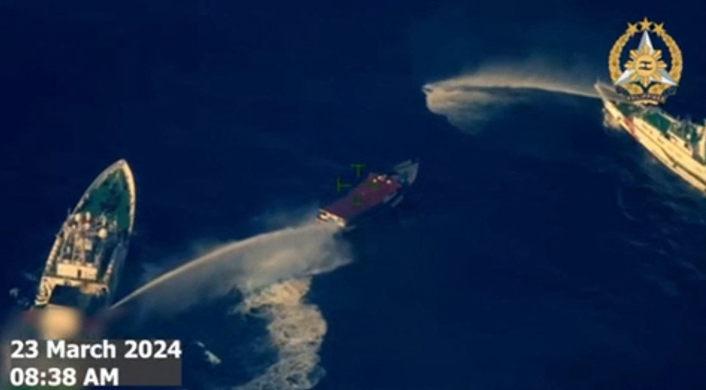 Frame grab from  aerial video footage taken by the Philippine military shows Chinese coastguard ships deploying water cannon against a Philippine boat near the Second Thomas Shoal. Photo: AFP 