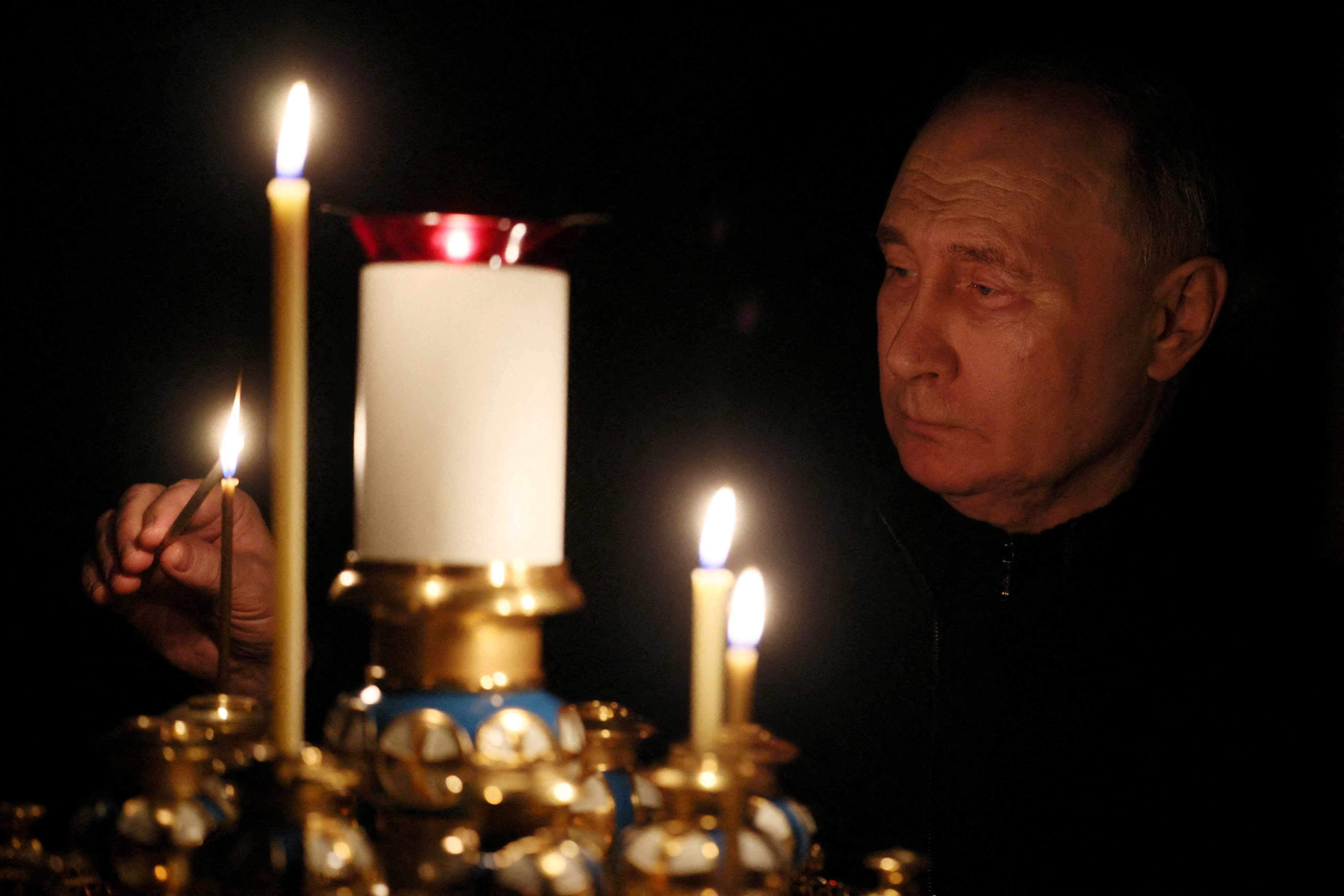 Russian President Vladimir Putin lights a candle in memory of the victims of Friday’s Crocus City Hall attack, at the Novo-Ogaryovo state residence outside Moscow on Sunday. Photo: Sputnik/Mikhail Metzel / Pool via Reuters
