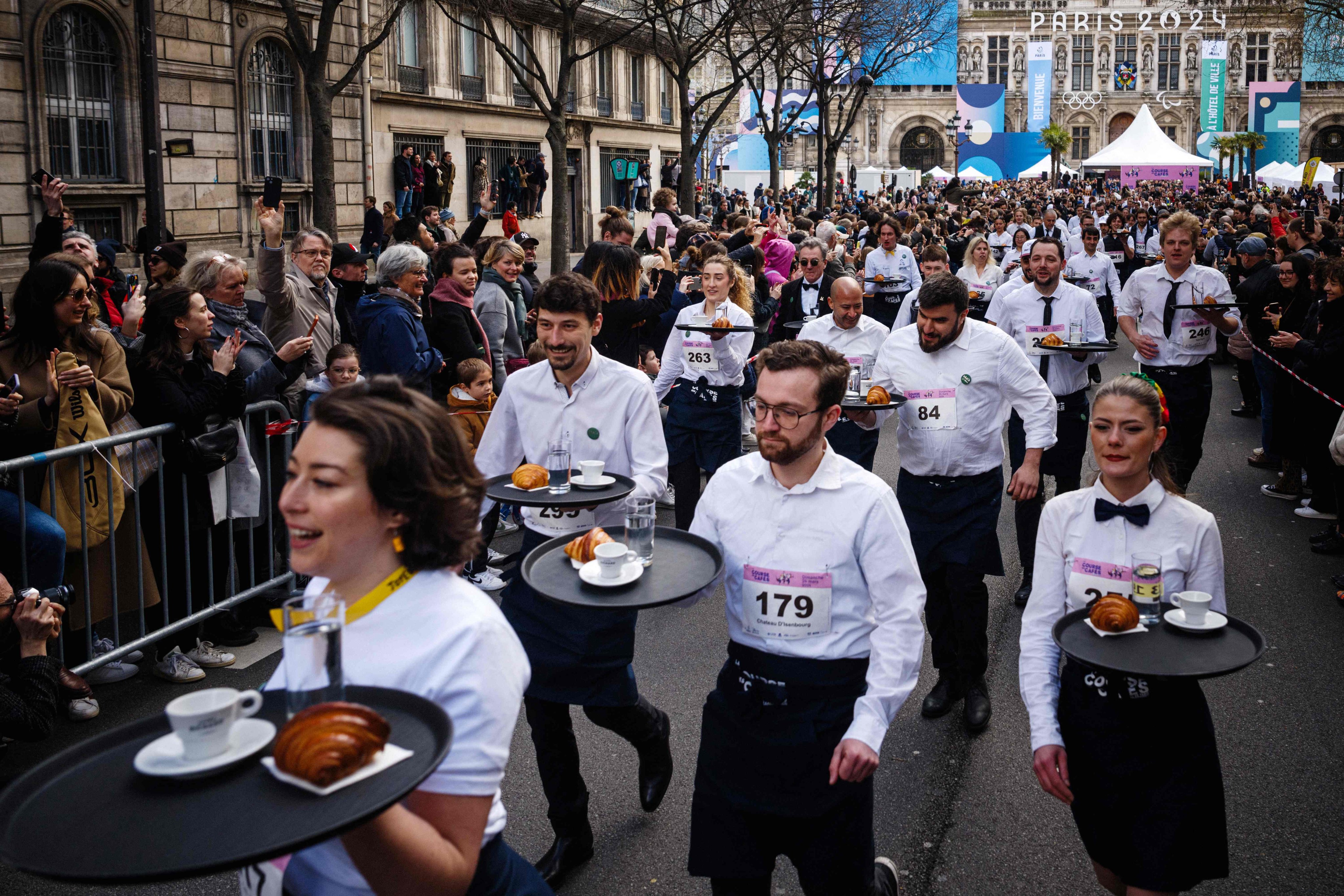 Waiters and waitresses at the start of the traditional “Course des cafes” (the cafes’ race), in front of the City Hall in central Paris, France on Sunday. Photo: AFP