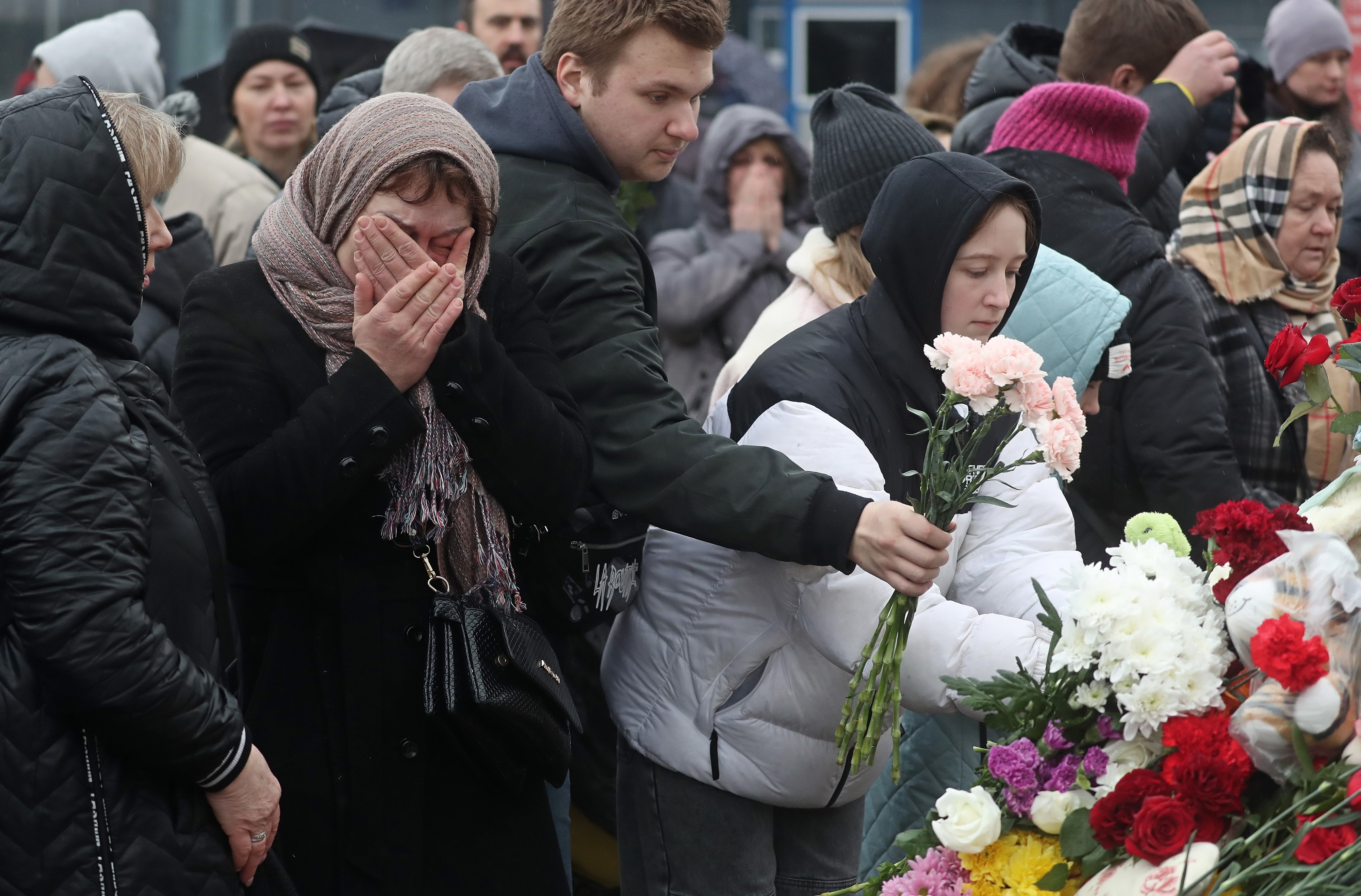 People mourn and bring flowers at the Crocus City Hall concert venue following a terrorist attack. Photo: EPA-EFE