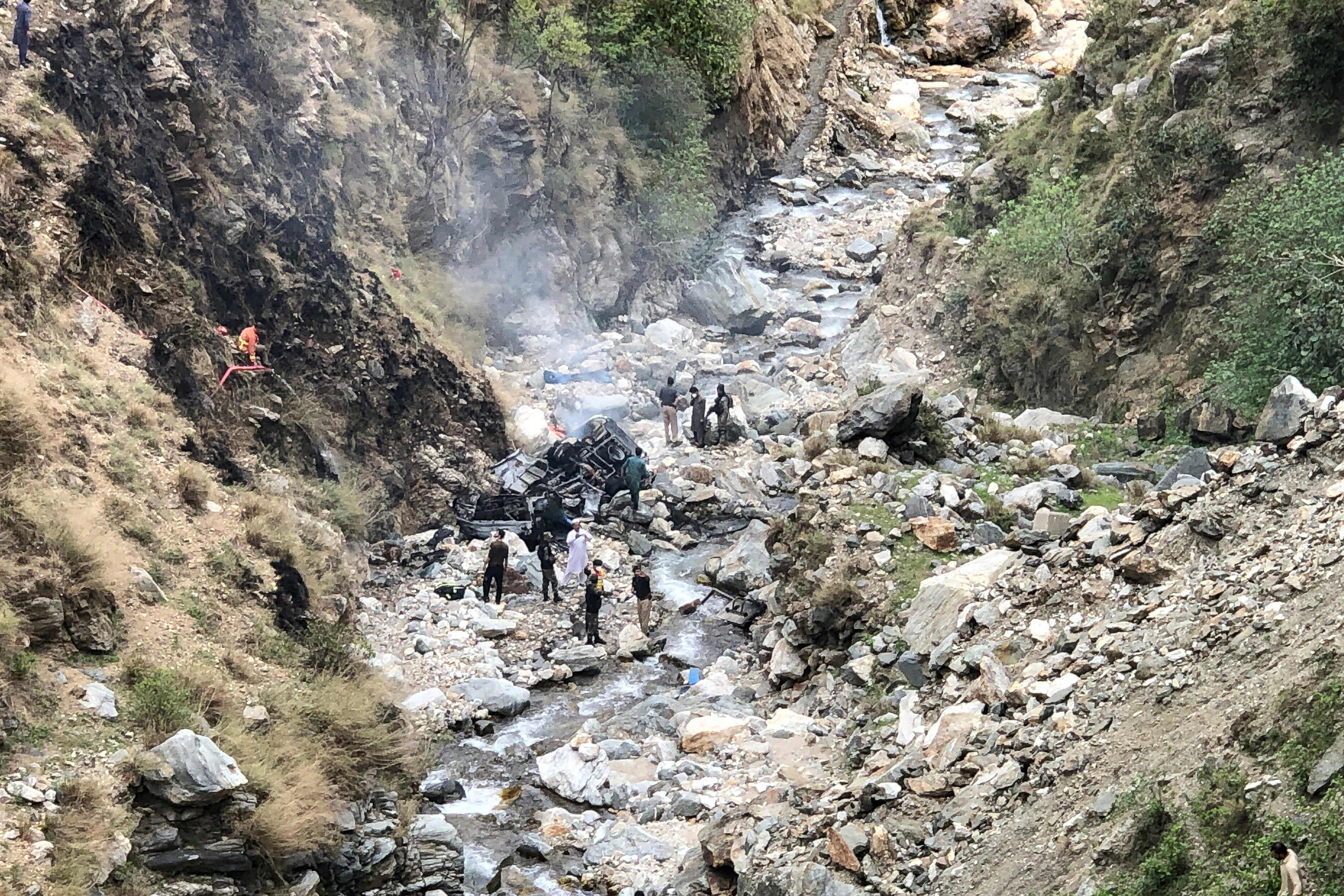 Security officials inspect the wreckage of a vehicle which was carrying Chinese nationals that plunged into a deep ravine off the mountainous Karakoram Highway after a suicide attack near Besham city in the Shangla district of Khyber Pakhtunkhwa province, Pakistan, on Tuesday. Photo: AFP