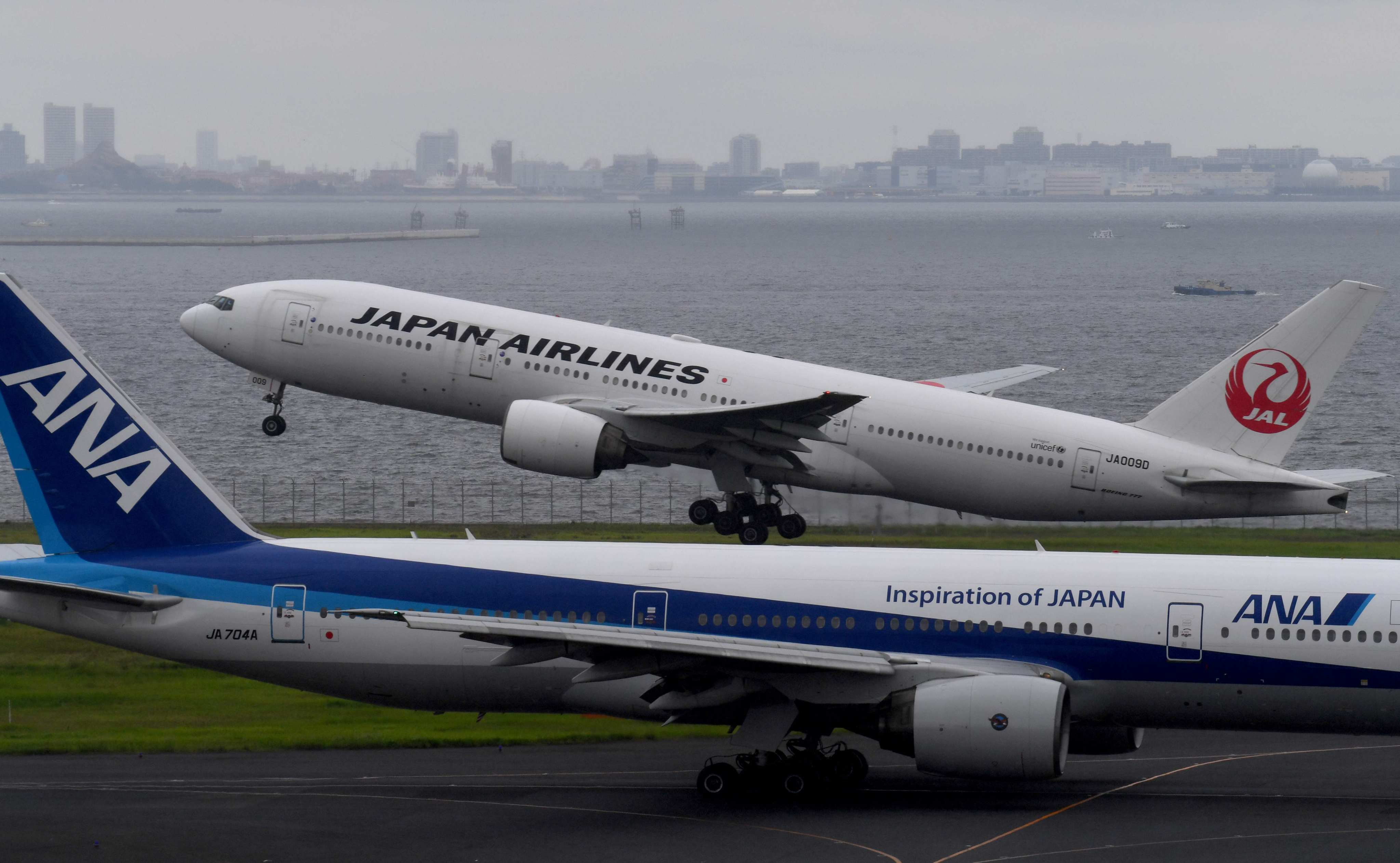 A Japan Airlines (JAL) passenger jet taking off next to an All Nippon Airways (ANA) jet at Haneda International Airport in Tokyo. Photo: AFP
