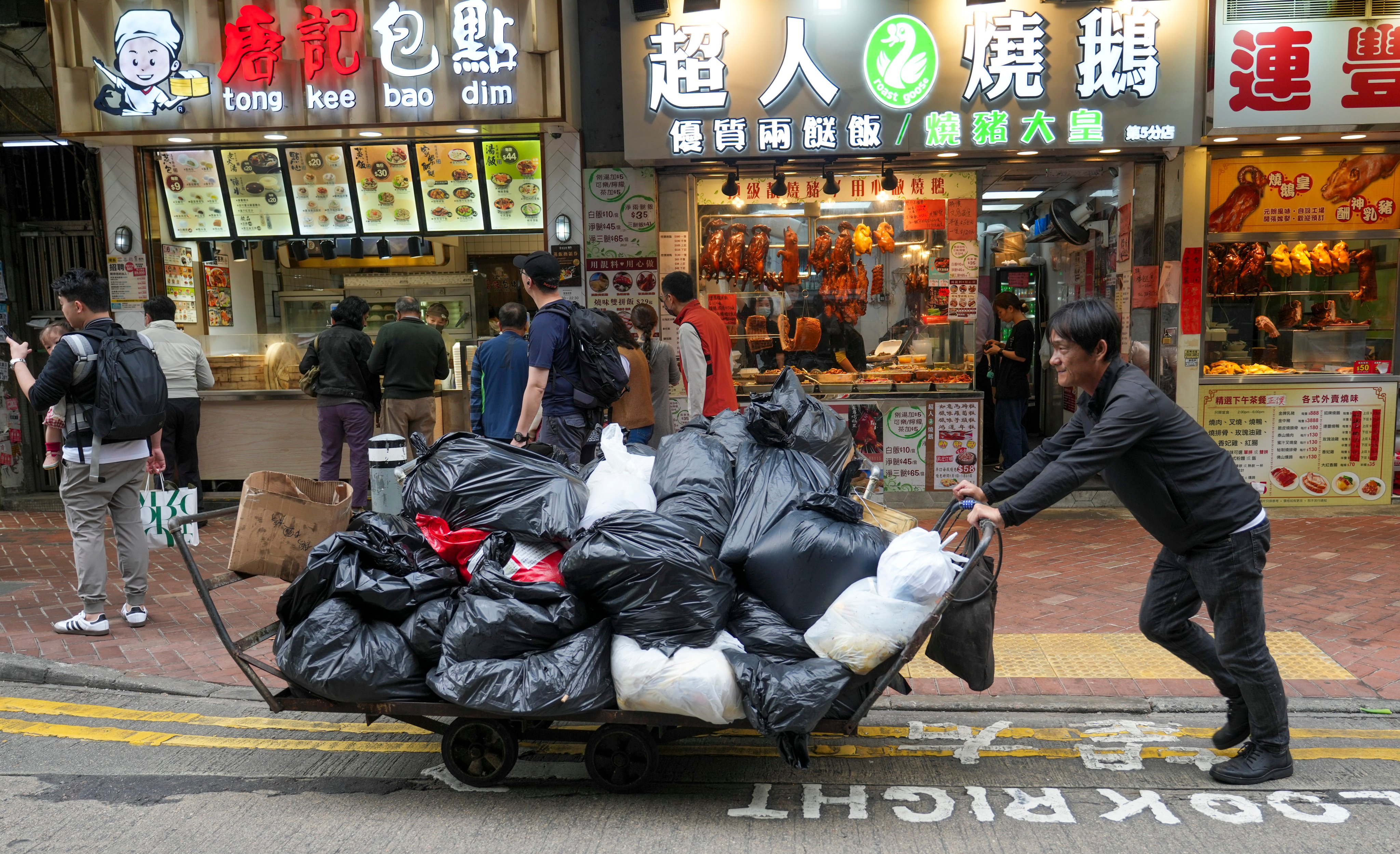 A worker pushing rubbish bags on a trolley. The Legislative Council cleared the pay-as-you-throw scheme in August 2021. Photo: Sam Tsang