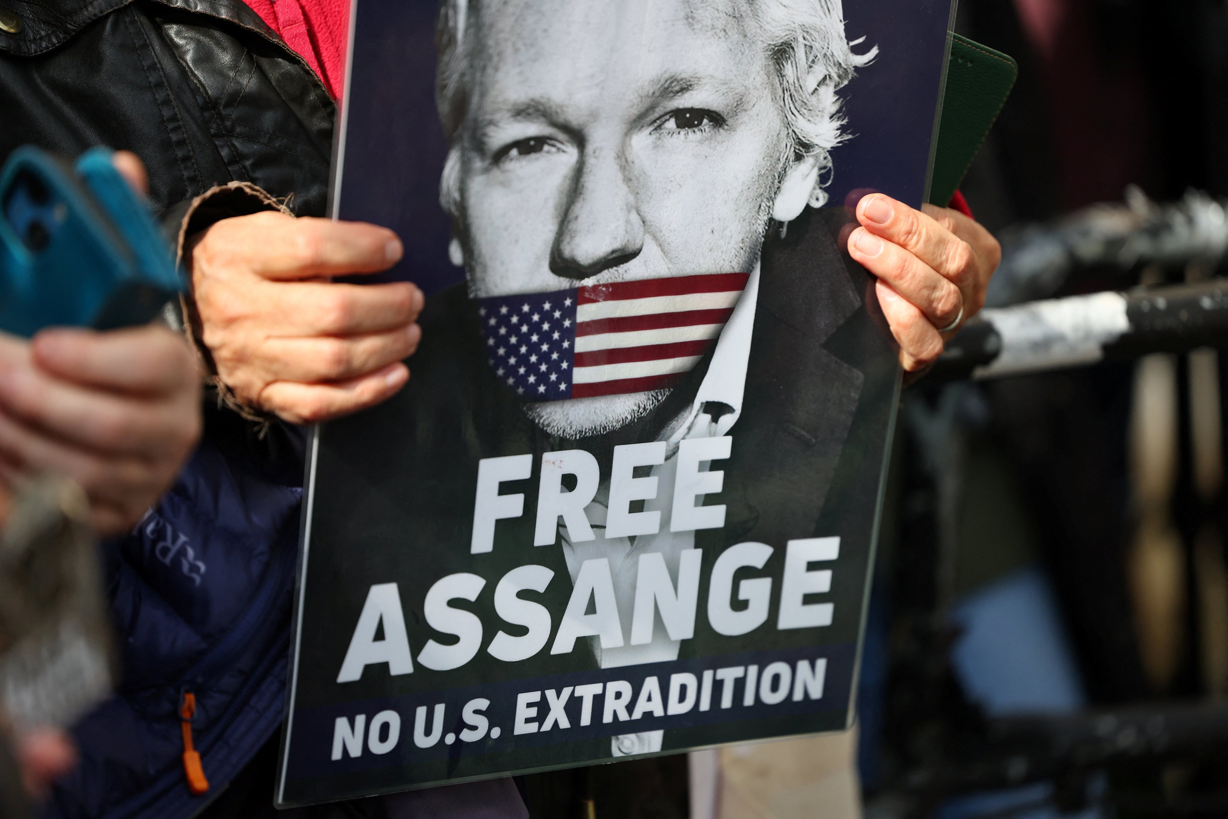 A supporter of WikiLeaks founder Julian Assange holds a sign. Two UK judges on Tuesday delayed a decision on whether to grant Assange a last-ditch appeal against extradition to the United States, giving Washington three weeks to provide “assurances” in the case. Photo: Reuters