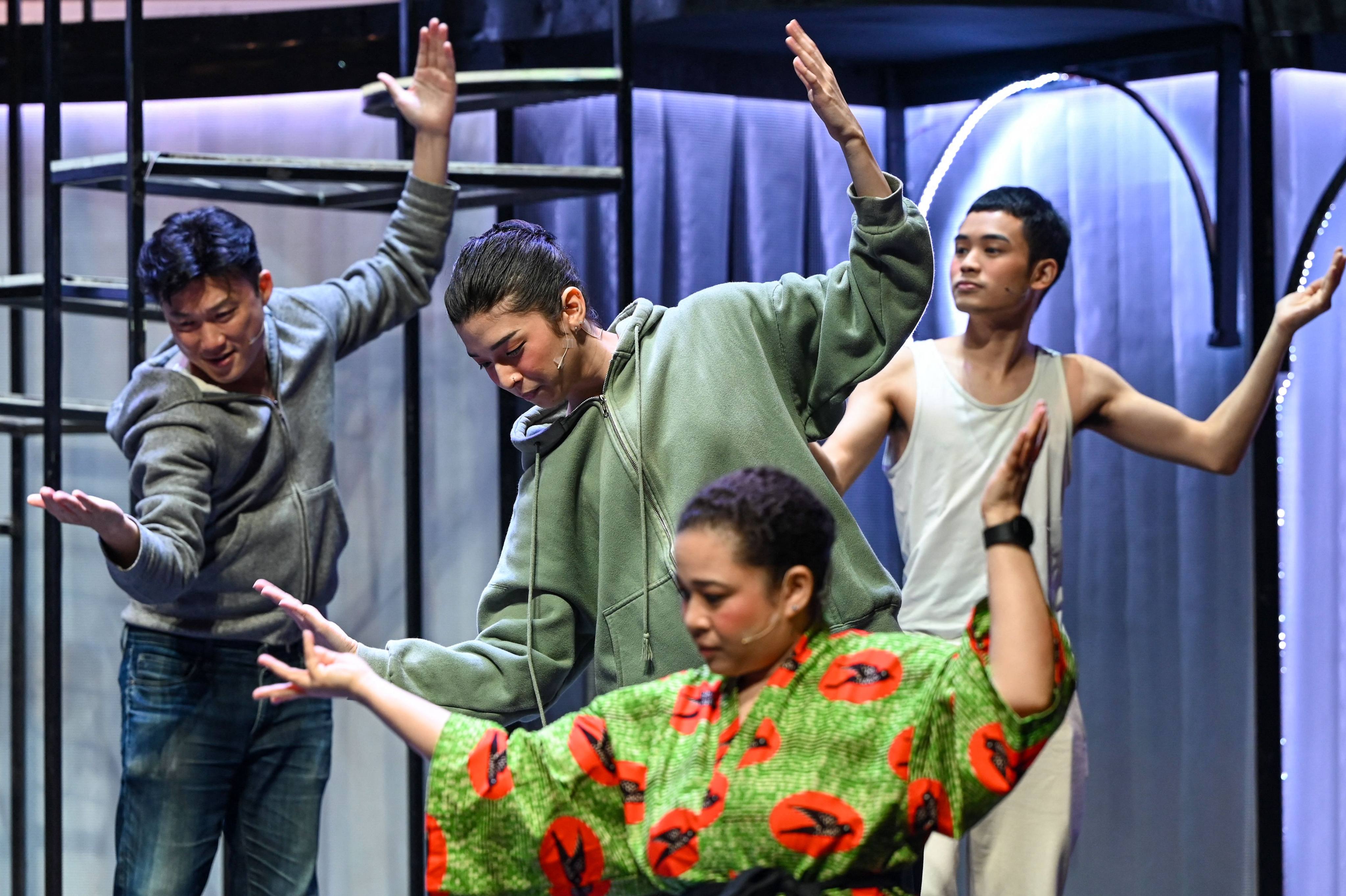 Loo (centre) warms up with other actors during a rehearsal before their performance at a theatre in Singapore last year. Photo: AFP