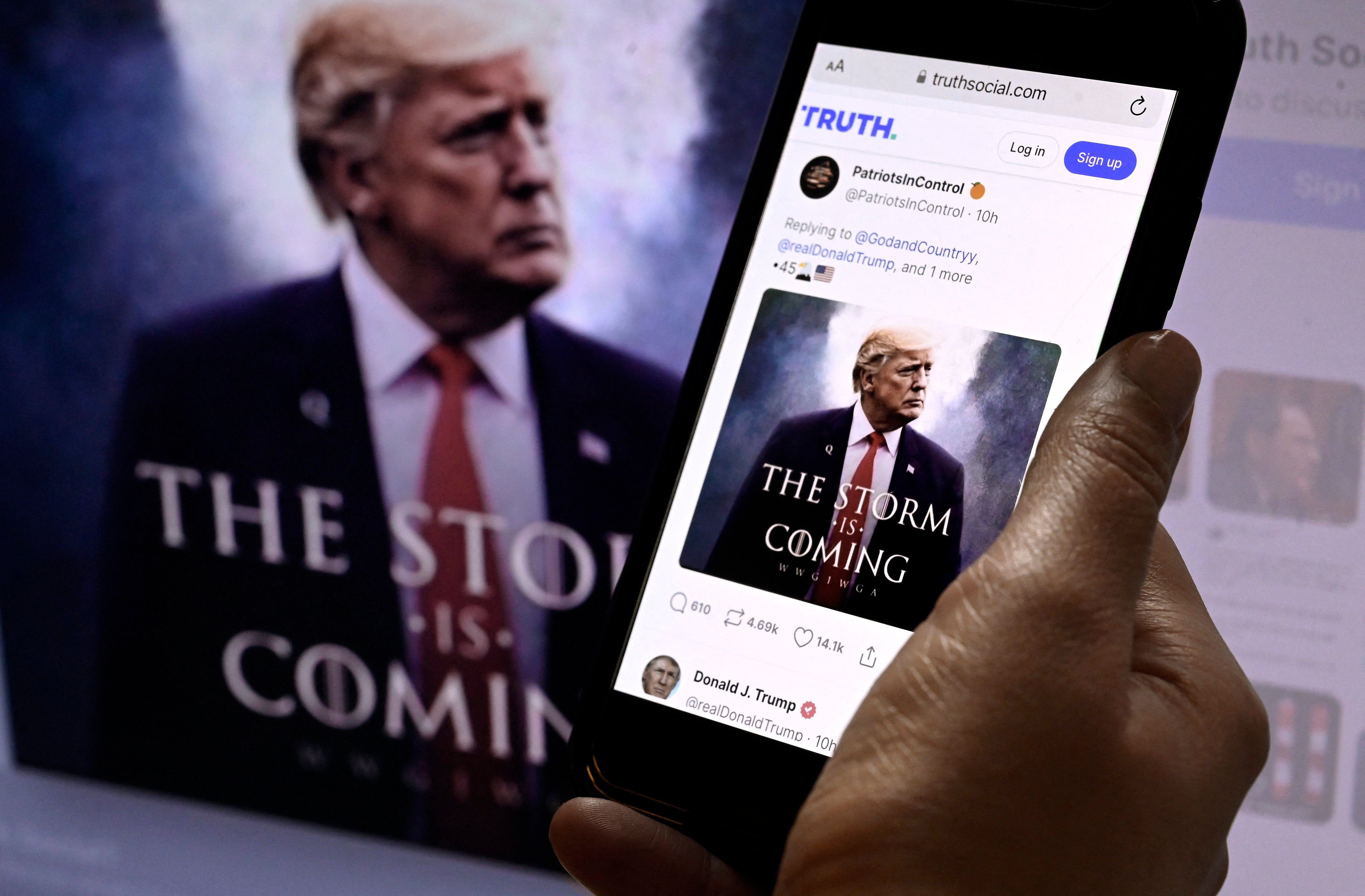 Former US president Donald Trump’s Truth Social account on a mobile device with an image of Trump in the background in Washington, DC on September 13, 2022. Photo: AFP