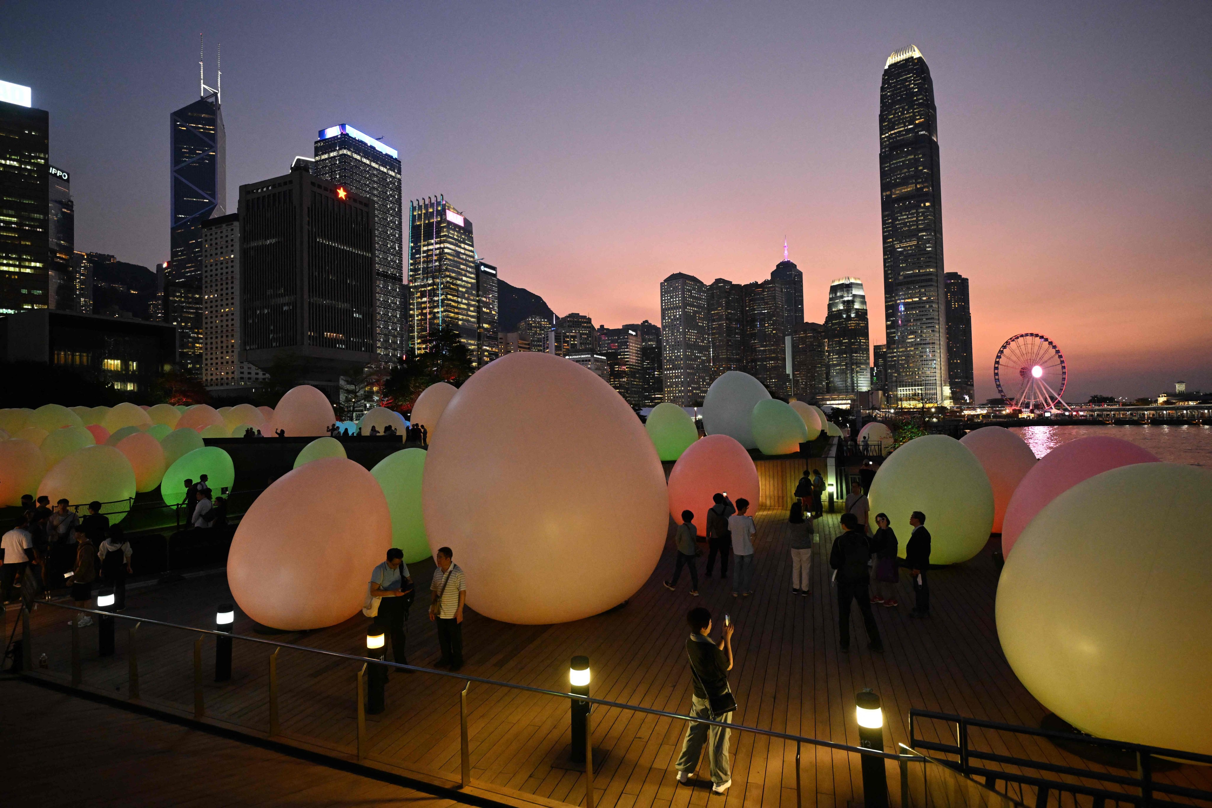 An installation by Japanese art collective teamLab, which features some 200 giant egg-shaped objects that change colour to music, is part of Hong Kong’s Art@Harbour 2024 initiative launched on March 25. Photo: AFP