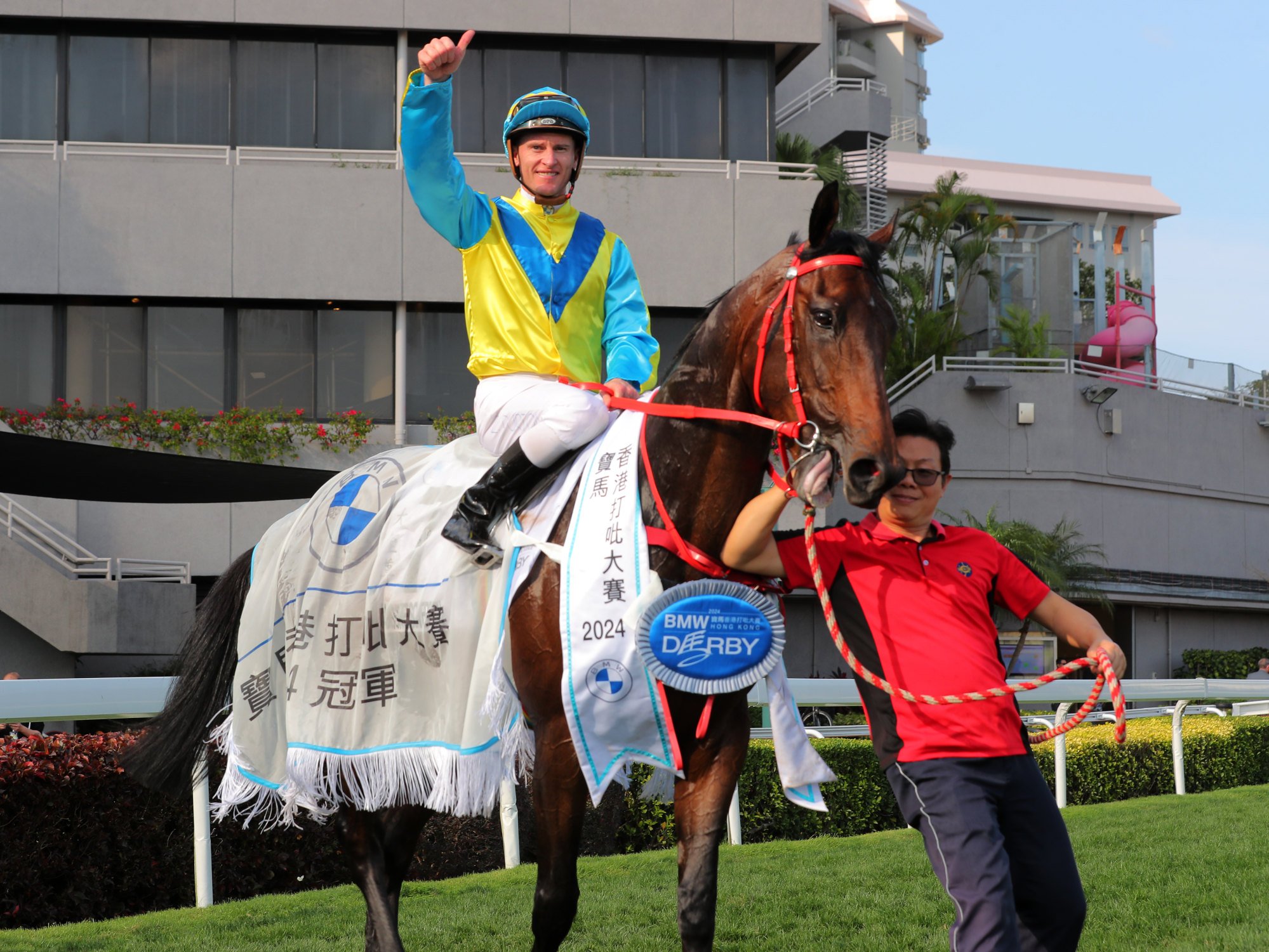 Zac Purton celebrates his Hong Kong Derby win on Massive Sovereign.