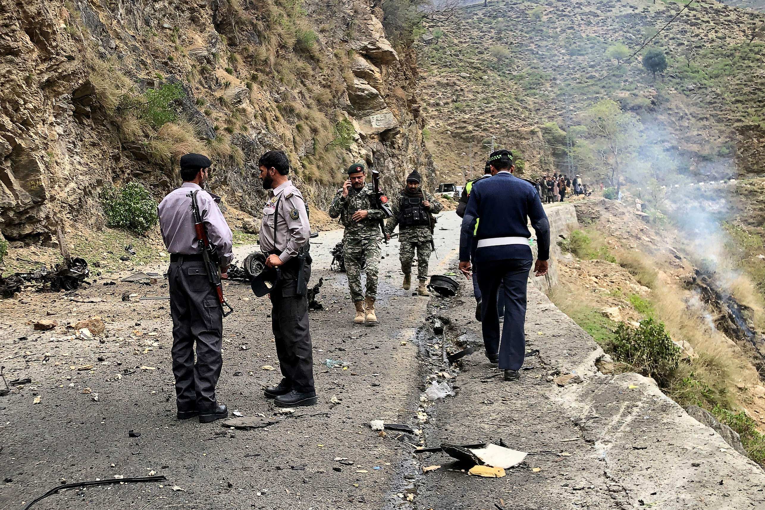 Security personnel inspect the site where a suicide bomber rammed a vehicle into a convoy of Chinese engineers working on a dam project in northwest Pakistan on Tuesday. Photo: AFP