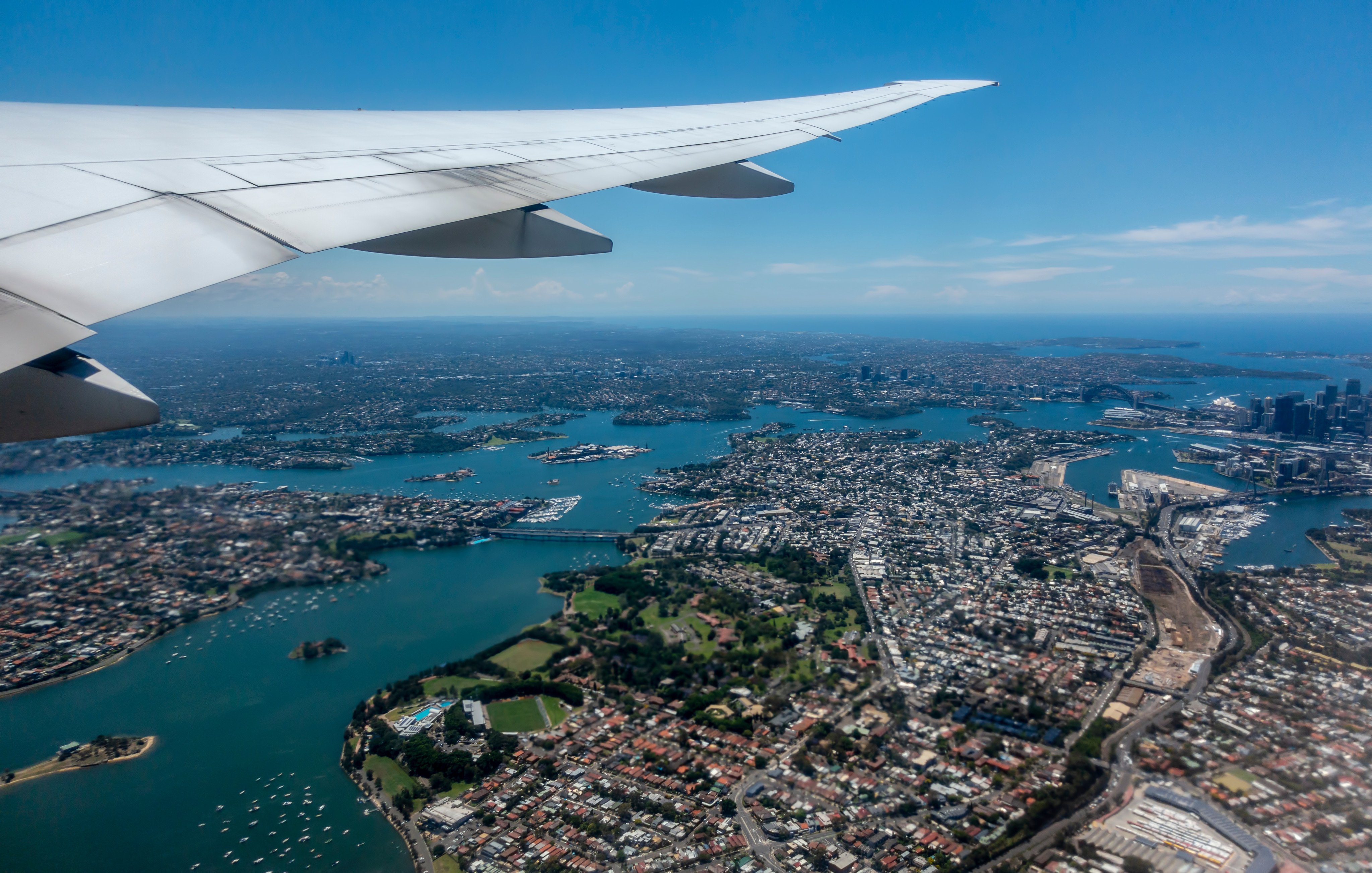 Sydney Harbour seen from a flight newly taken off from Sydney for Los Angeles. Rising airfares, the carbon cost of long-haul travel and the prospect of fewer flights and even higher fares are headwinds for the travel industry in Australia and New Zealand. Photo: Shutterstock