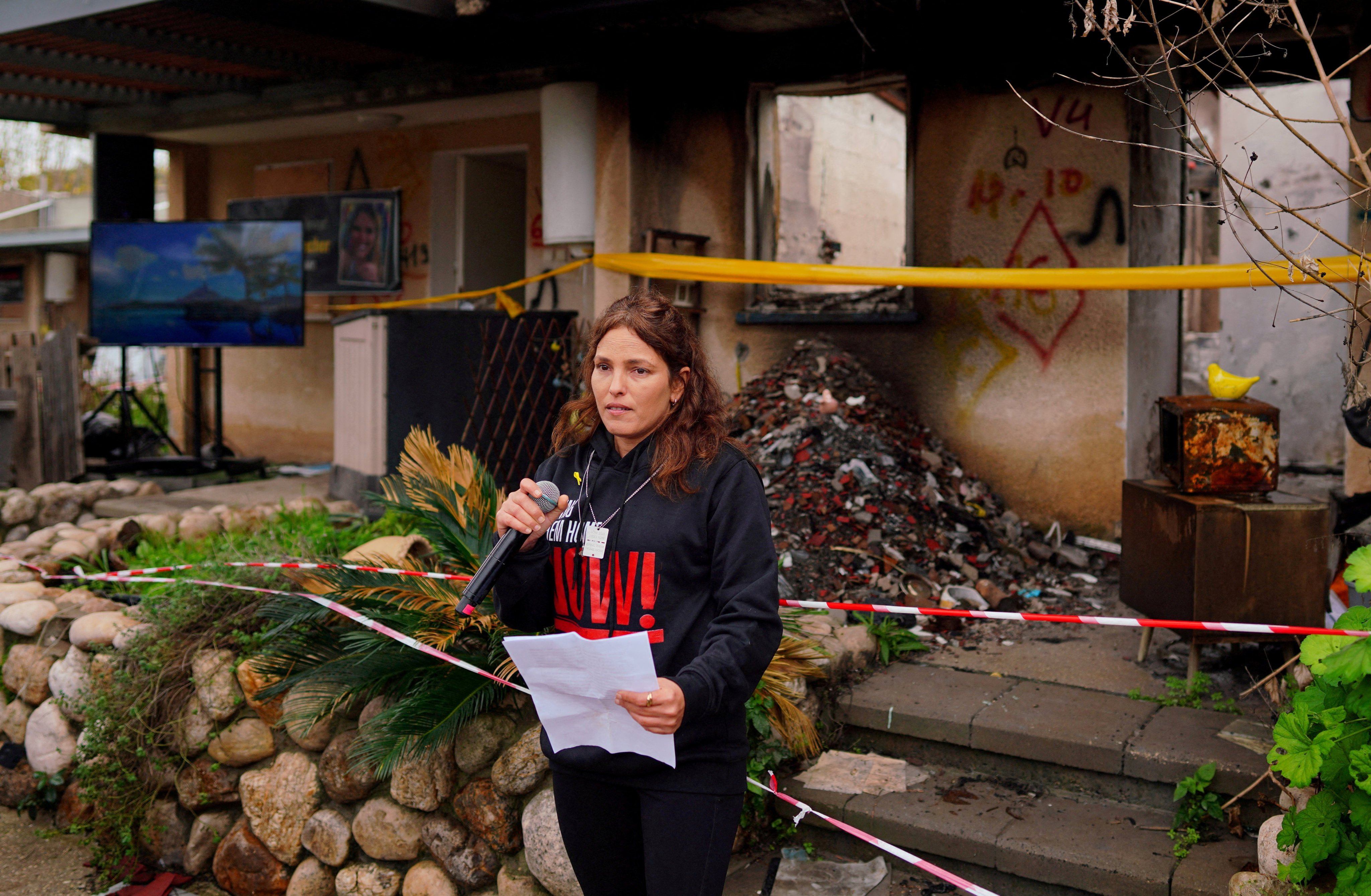 Released hostage Amit Soussana, kidnapped during the October 7 Hamas attack on Israel, in front of her destroyed home at the Kibbutz Kfar Aza, Israel, on January 29. Photo: Reuters