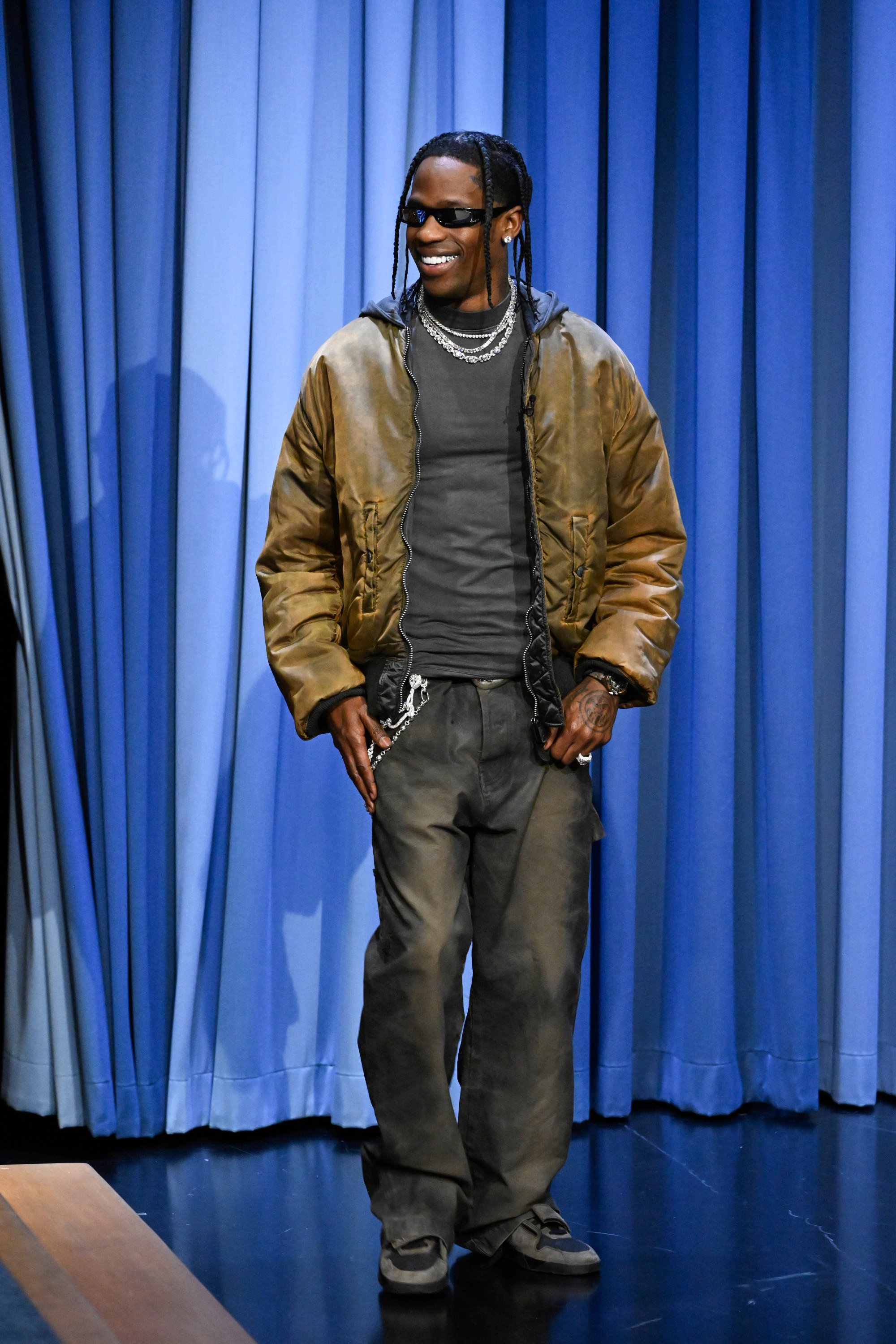 Rapper Travis Scott appeared on The Tonight Show Starring Jimmy Fallon in December in trademark relaxed style with a distressed bomber jacket topped with necklace bling. Photo: Getty Images