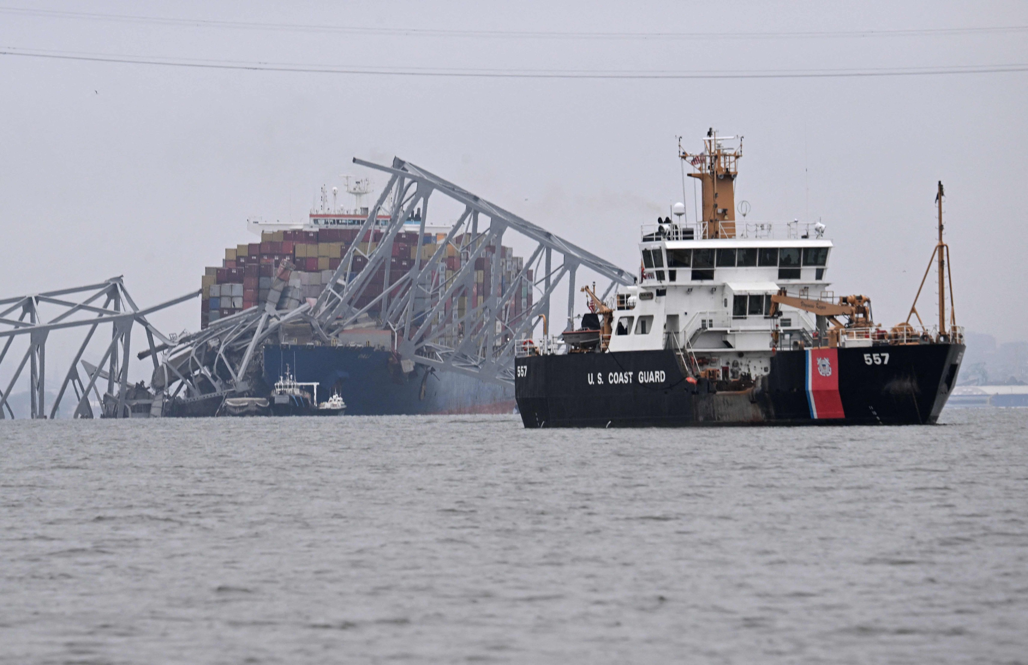 The US coastguard cutter Frank Drew (right) patrols near the collapsed Francis Scott Key Bridge after it was struck by a container ship in Baltimore, Maryland, on March 27. Photo: AFP