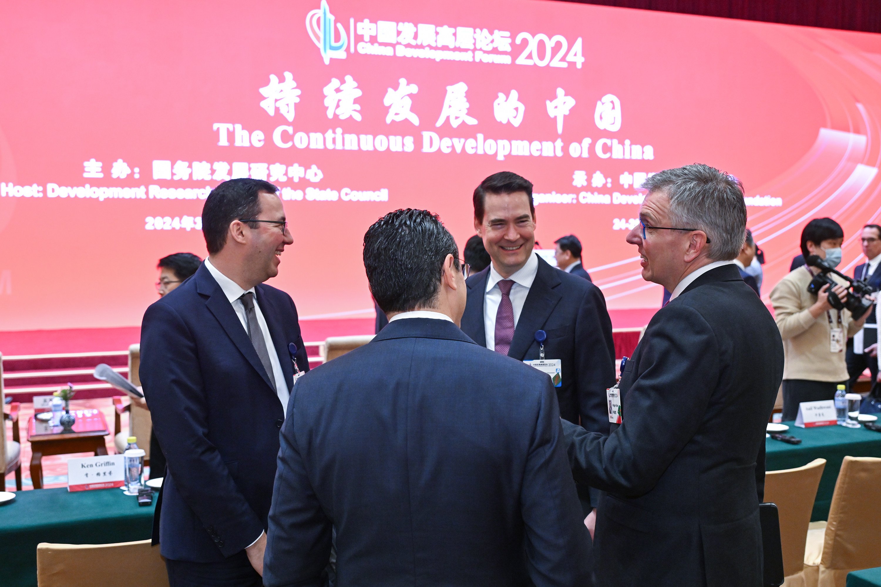 People chat before the opening ceremony of the China Development Forum 2024 in Beijing. Photo: Xinhua