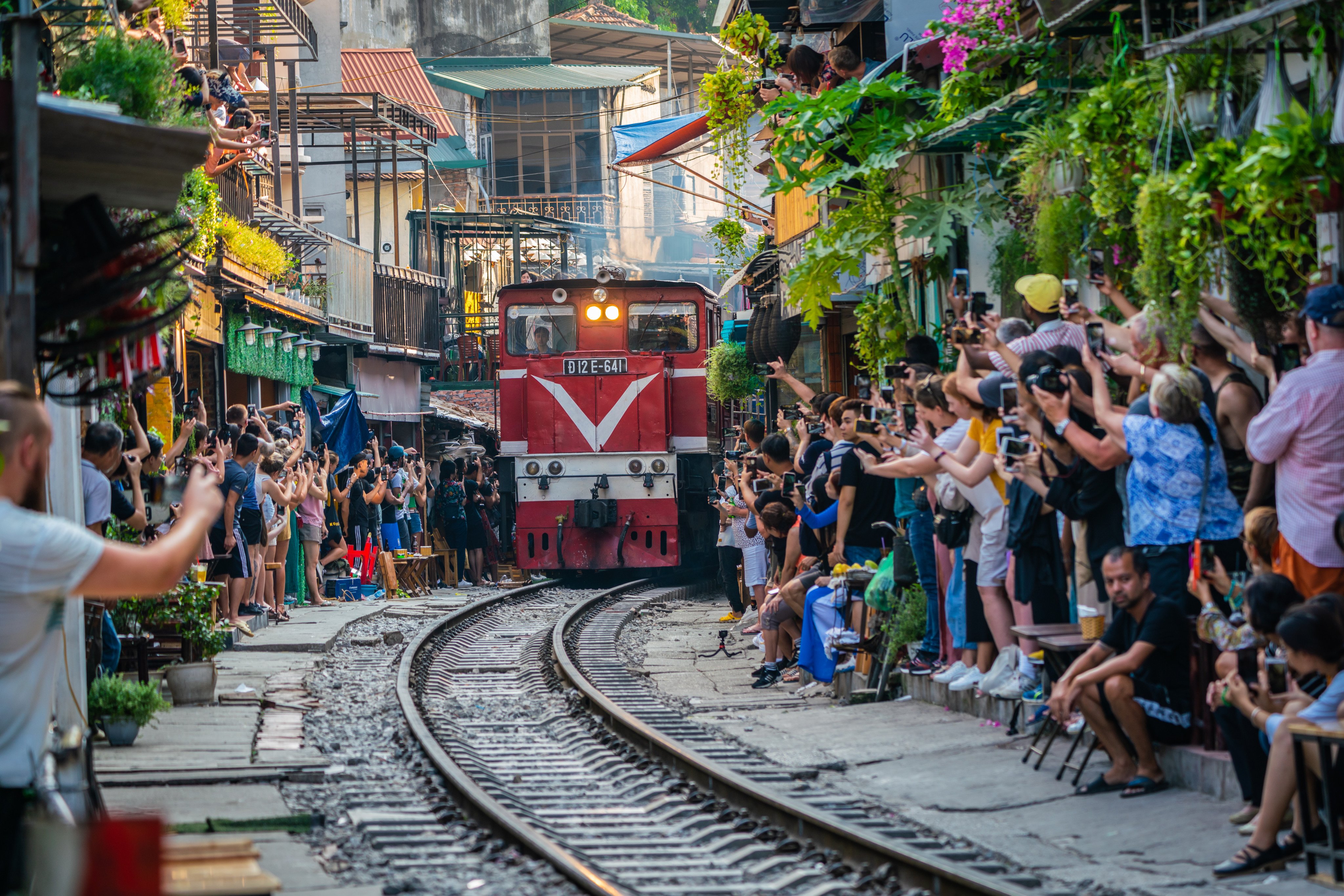 A railway line in Hanoi’s Old Quarter is a notoriously dangerous place for tourists, which is why authorities are taking measures to restrict their access. Elsewhere, cities and countries tax tourists or charge entry fees to manage visitor flows and encourage more environment-friendly travel. Photo: Shutterstock