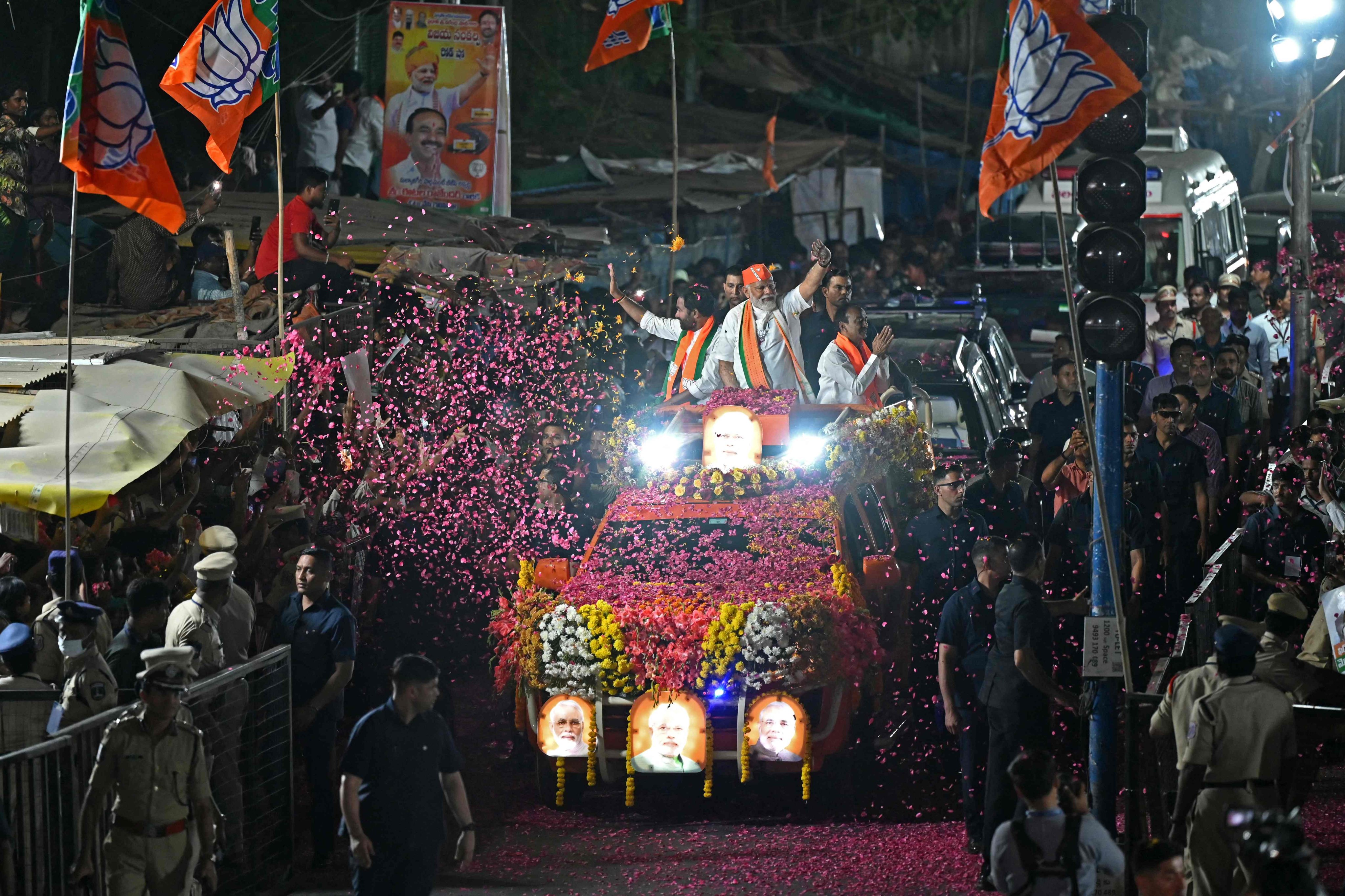 Indian Prime Minister Narendra Modi waves to his supporters from atop a vehicle during the Bharatiya Janata Party’s campaign ahead of national elections in Hyderabad on March 15. Photo: AFP