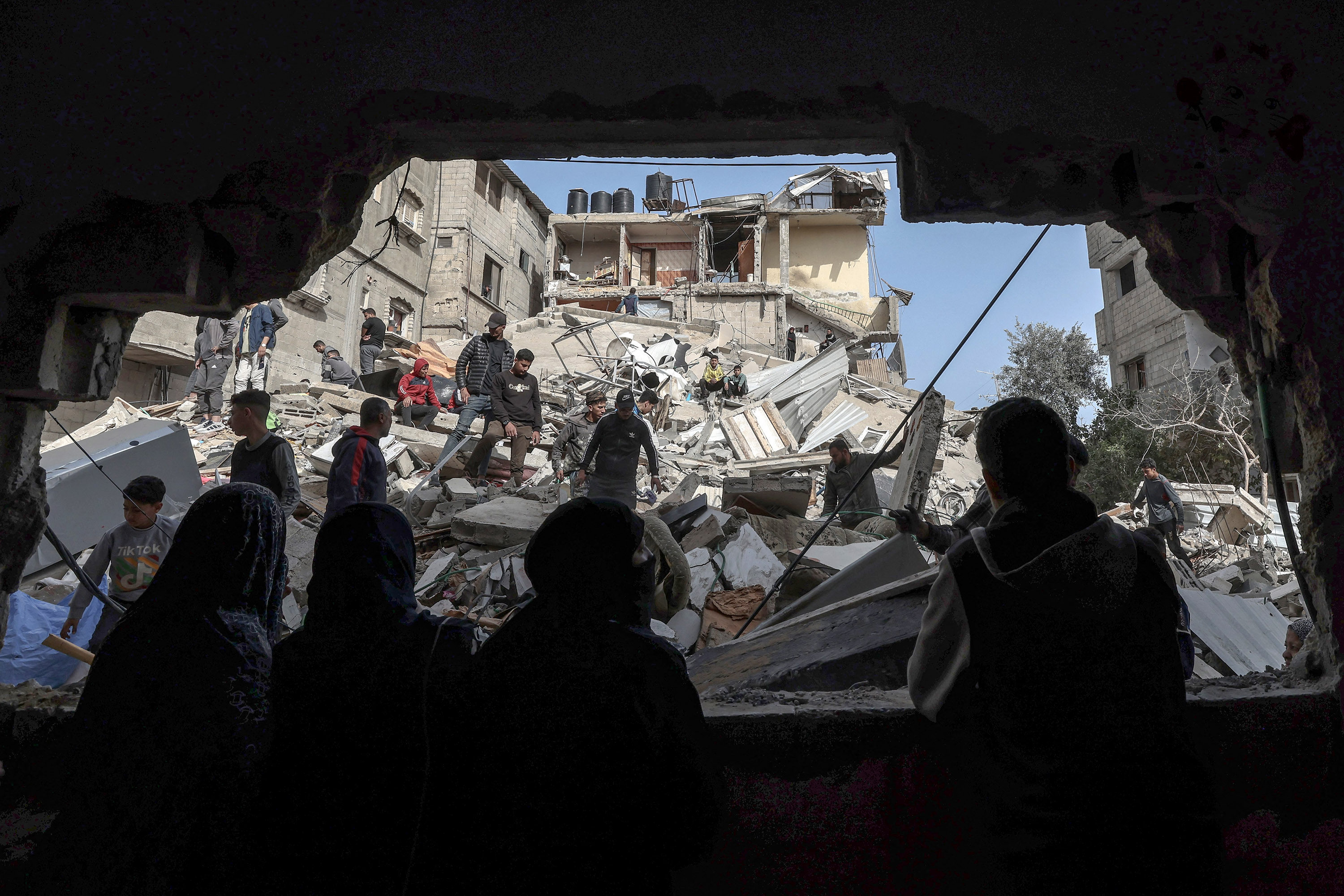 Palestinians check the rubble of buildings that were destroyed during overnight Israeli bombardment in Rafah. Photo: TNS