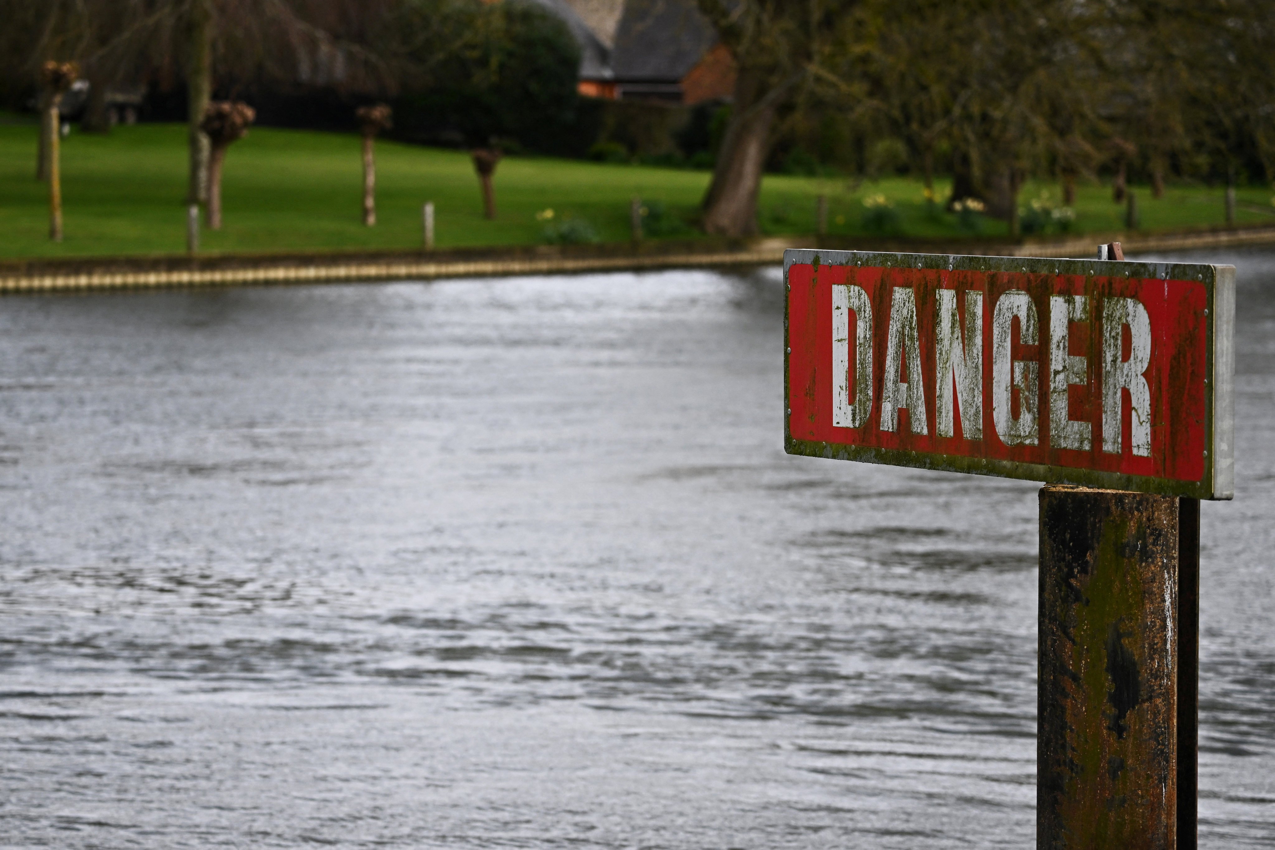 A “Danger” sign is seen on the River Thames, on the day data revealed sewage spills into England’s rivers and seas by water companies more than doubled last year. Photo: Reuters
