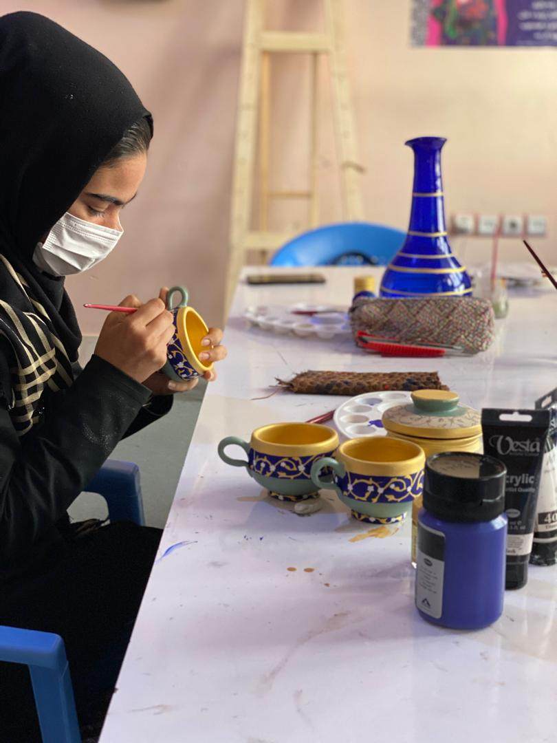 A woman paints cups at the Herat centre of non-profit Women’s Activities and Social Services Association (WASSA) in Afghanistan. Photo: Handout