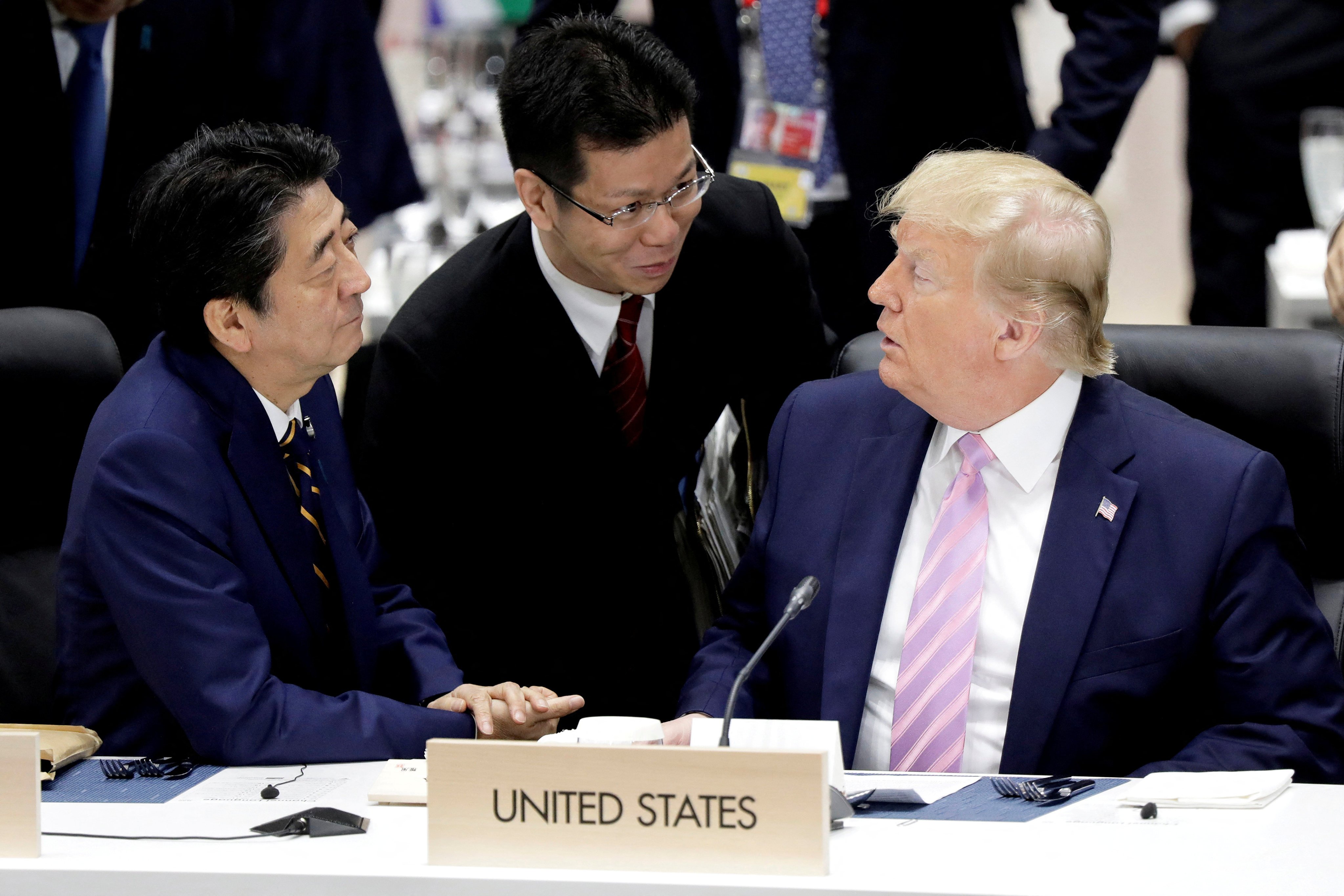 Sunao Takao (centre) helps with translation as then Japanese prime minister Shinzo Abe (left) and US president Donald Trump talk prior to a working lunch at the Group of 20 summit in Osaka, Japan, on June 28, 2019. The Japanese government has turned to Takao and others seen as having insight into Trump as it prepares for the possibility of his returning to the White House. Photo: Reuters