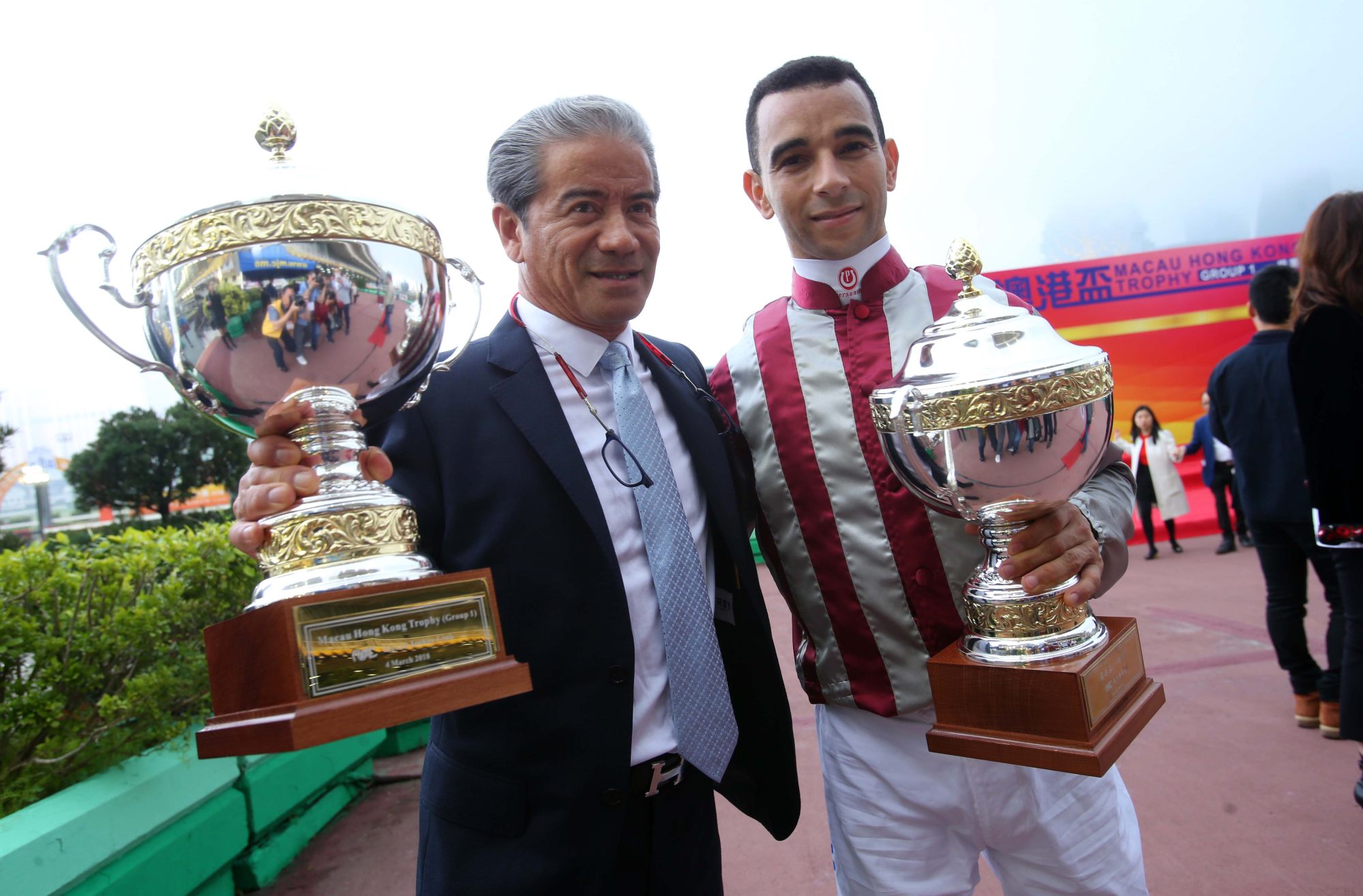 Trainer Tony Cruz and jockey Joao Moreira win the 2018 Macau Hong Kong Trophy with Romantic Touch.