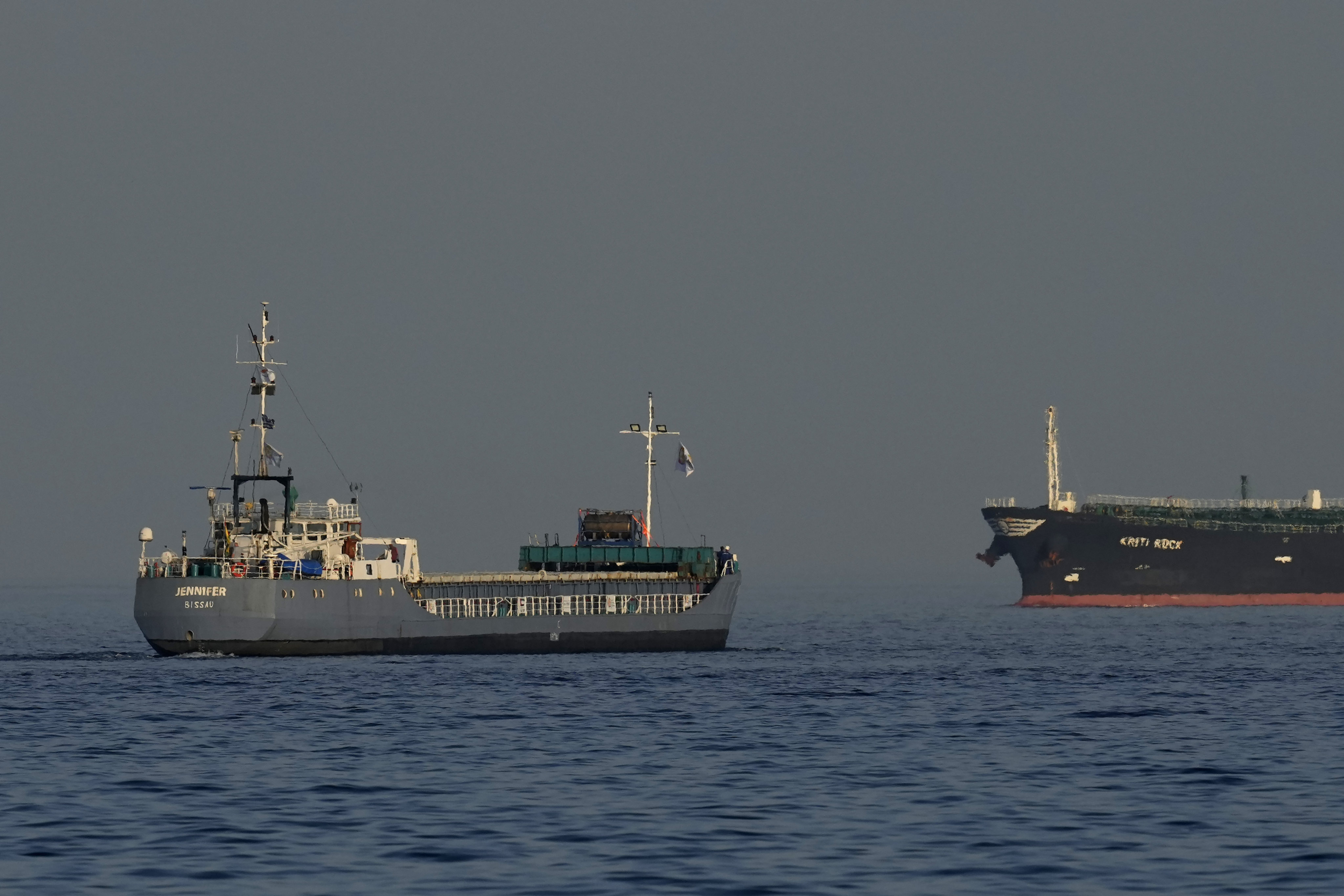 A cargo ship, left, one of three ships loaded with tinned food destined for Gaza, sails from the port in Larnaca, Cyprus on Saturday. Photo: AP