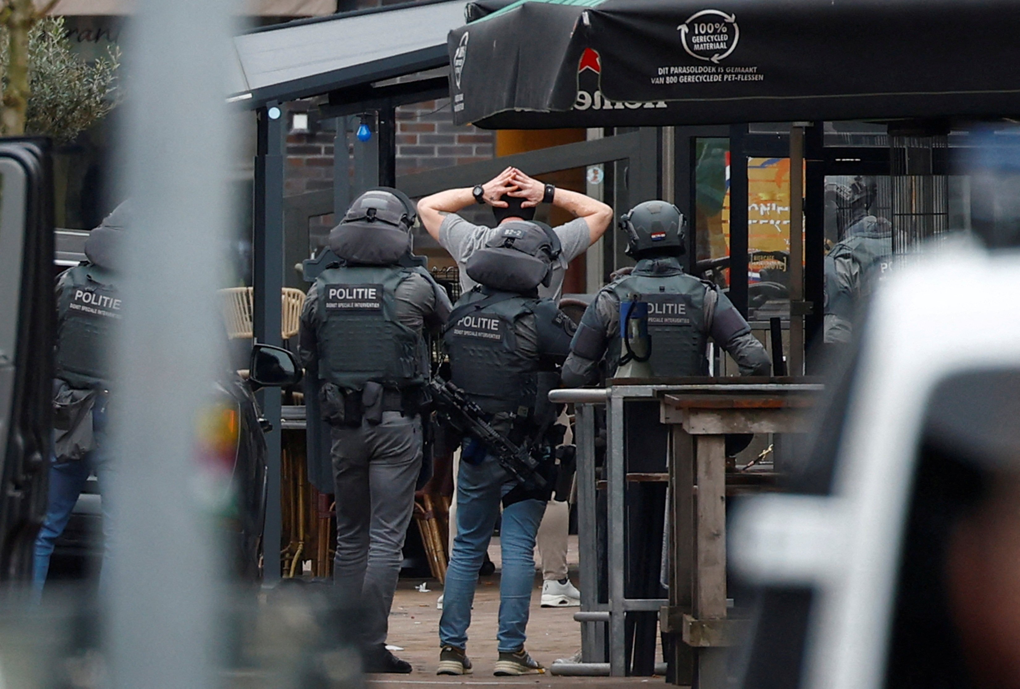 Dutch police detain a person near the Cafe Petticoat, where several people were being held hostage in Ede, Netherlands on Saturday. Photo: Reuters 