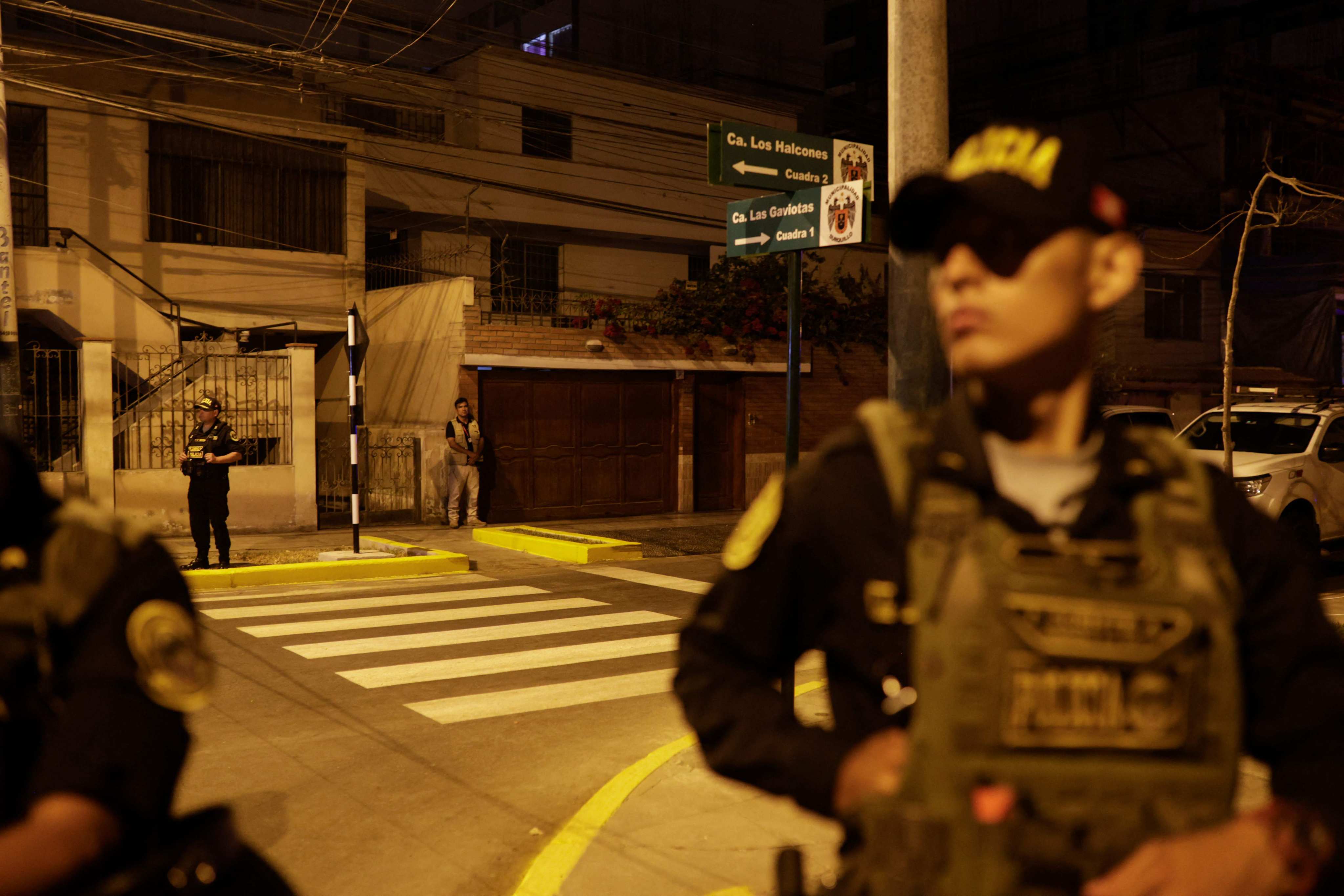 Police stand guard outside Peru President Dina Boluarte’s home during a raid ordered by the Attorney General’s Office, in Lima, Peru on Saturday. Photo: AFP