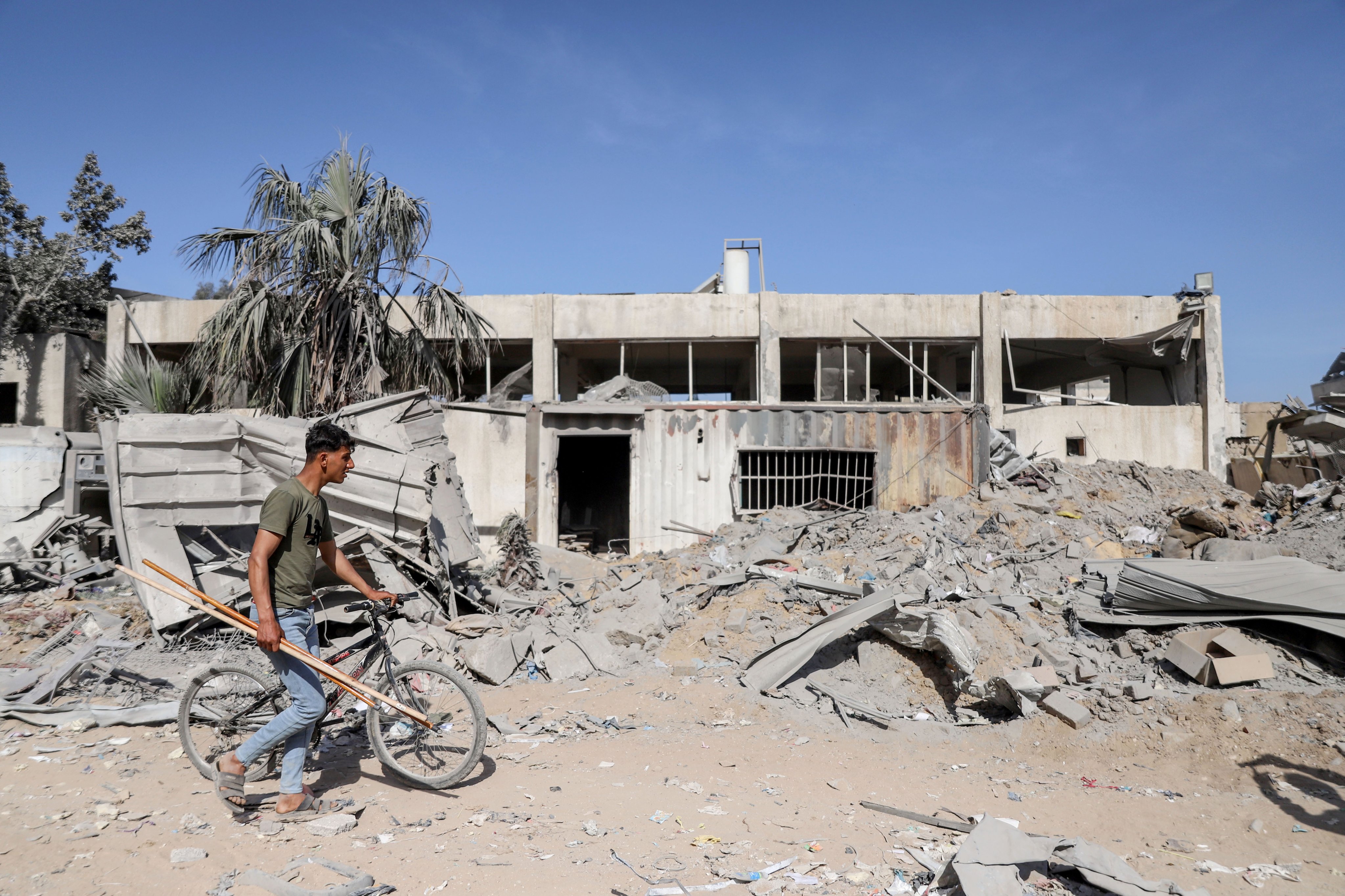 A Palestinian walks past al-Shifa Hospital in Gaza City on Monday after the Israeli army withdrew from the building following a two-week military operation. Photo: EPA-EFE
