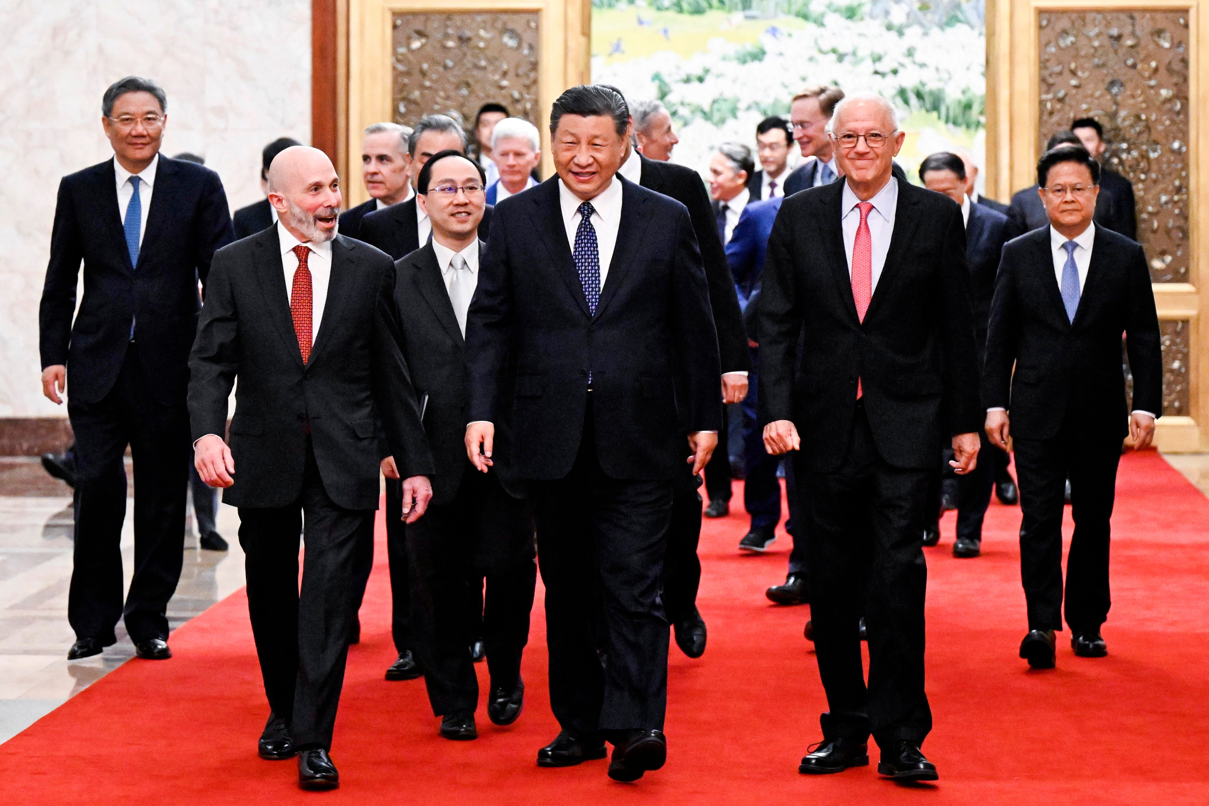 Chinese President Xi Jinping, centre, walks with representatives from US business, strategic and academic communities at the Great Hall of the People in Beijing on March 27. Xi promised the delegation more policy support to improve the business environment. Photo: Xinhua via AP