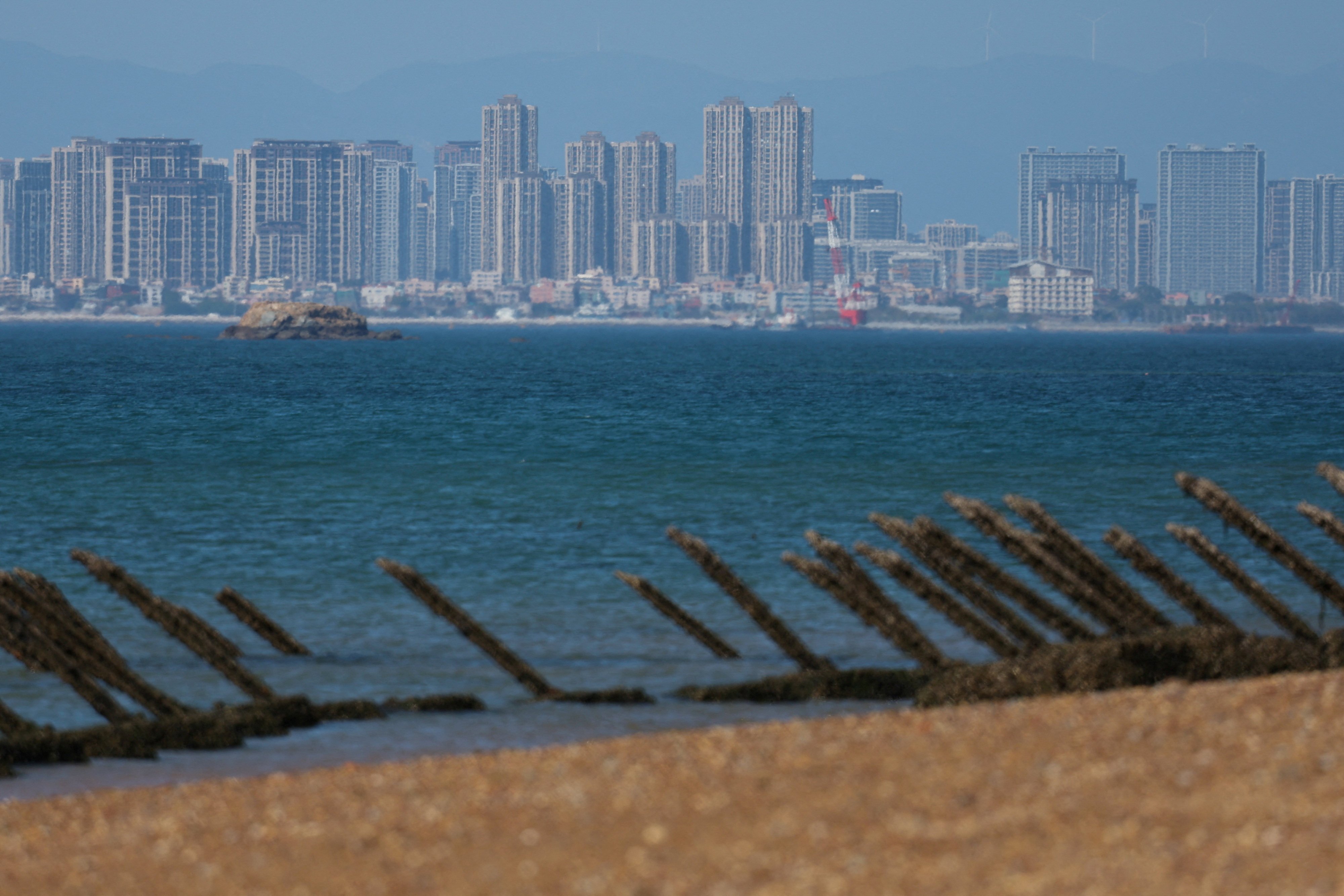 Anti-landing barricades are pictured on the beach at Quemoy, with the mainland Chinese city of Xiamen in the background. Photo: Reuters