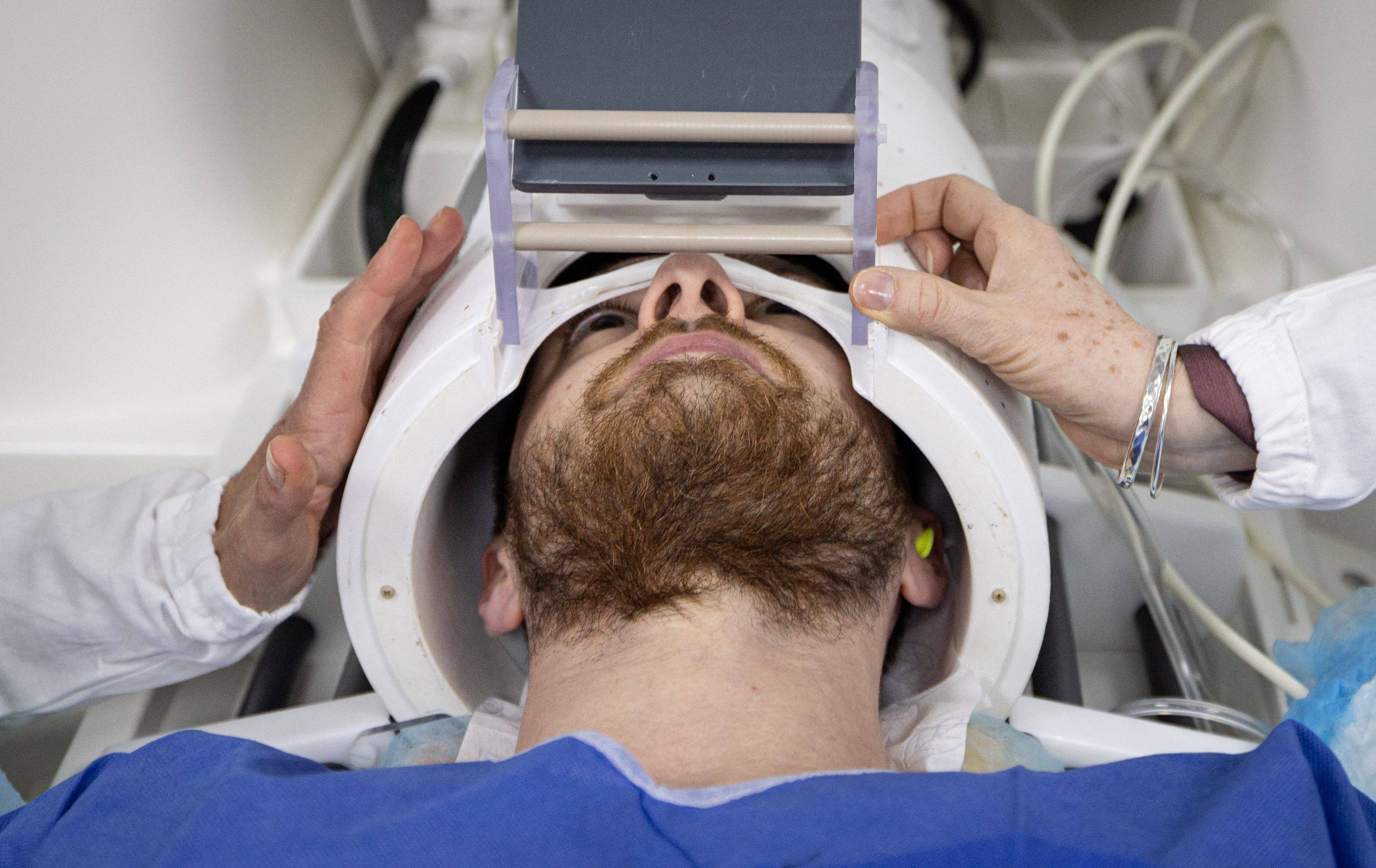 A volunteer takes part in an MR exam simulation. “Iseult”, the world’s most powerful MRI scanner, has delivered its first images of the human brain. Photo: AFP