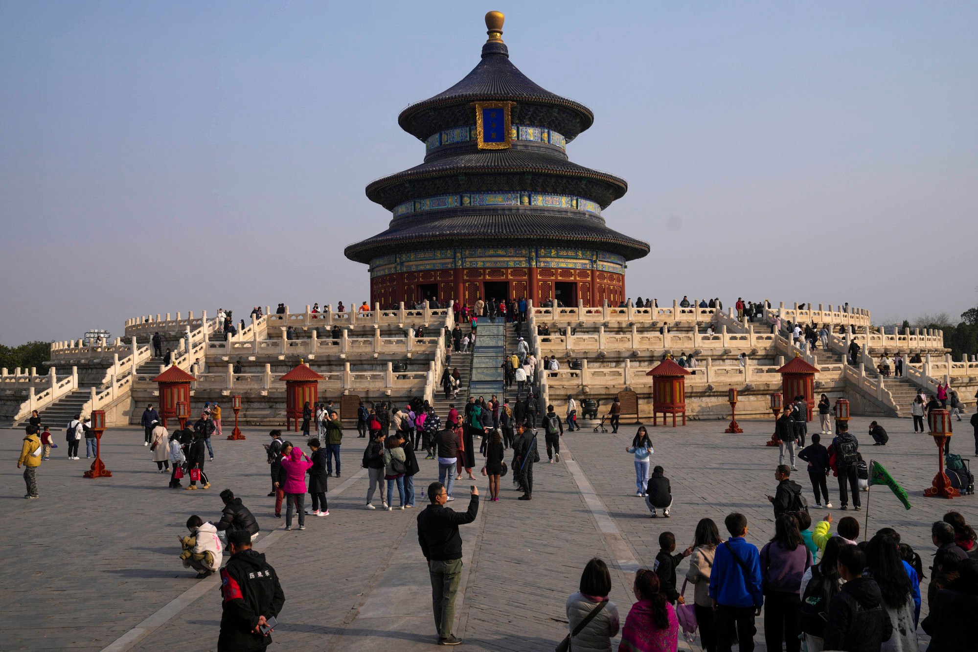 Visitors enjoy the sights of the Temple of Heaven Park in Beijing. Photo: AP