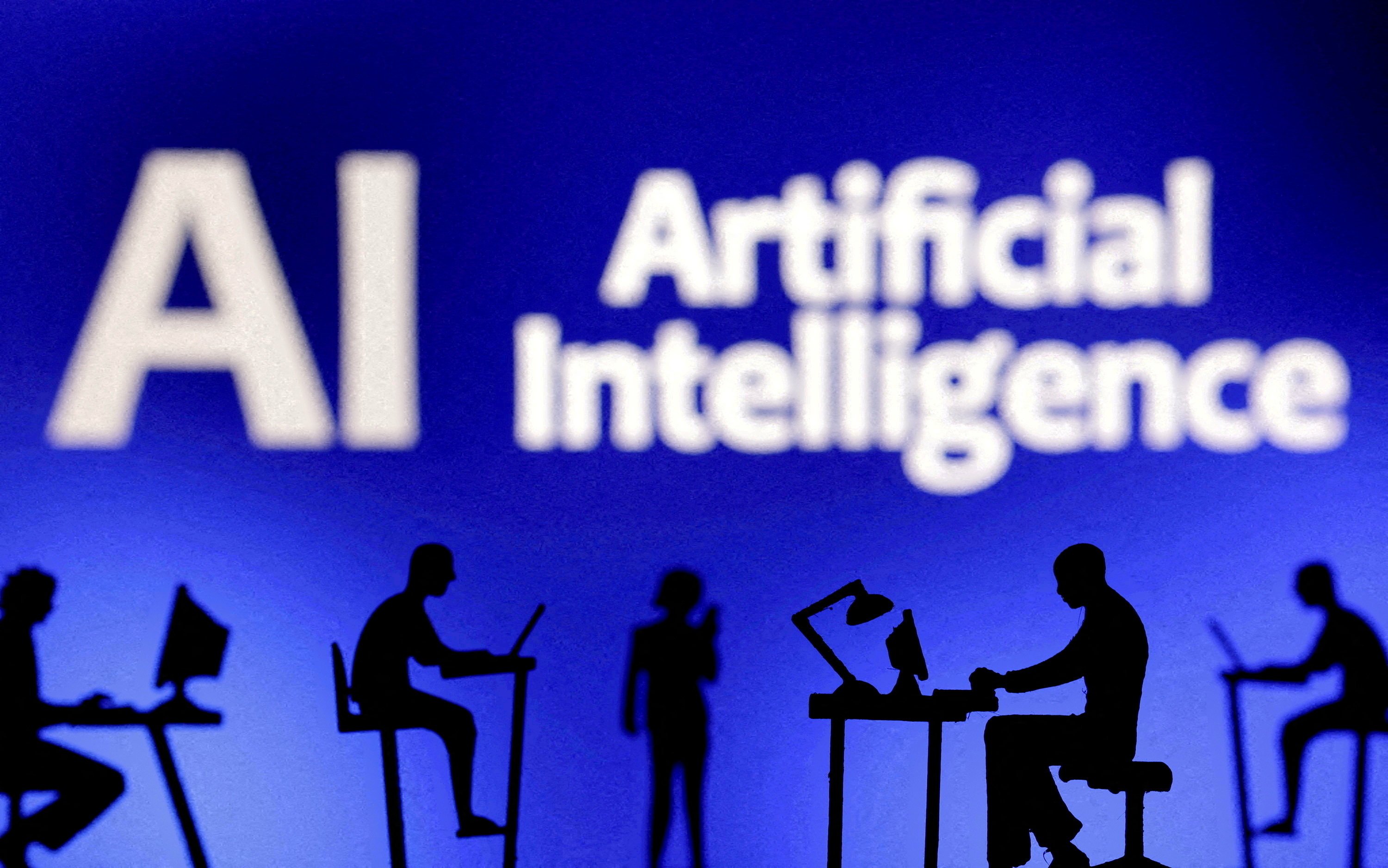 Figurines with computers and smartphones are seen in front of the words ‘Artificial Intelligence AI’ in this illustration taken on February 19, 2024. Photo: Reuters