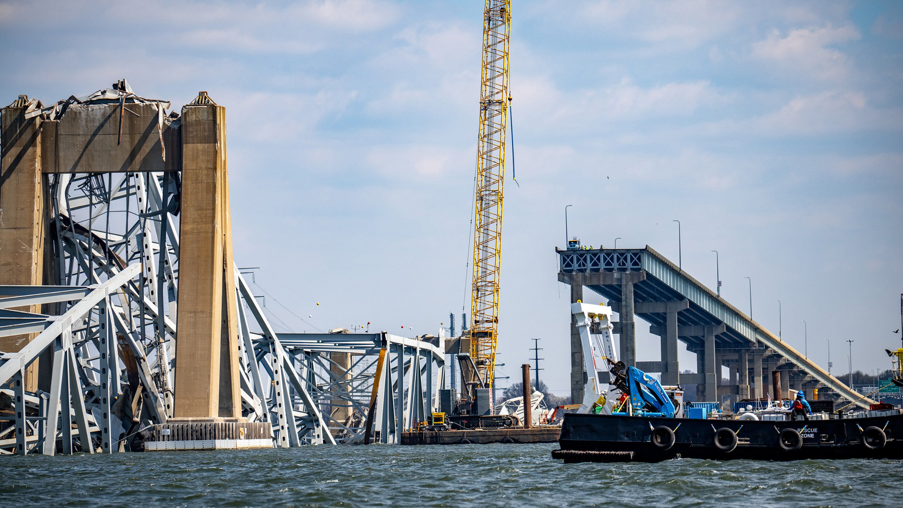 A crane is positioned by the wreckage of the Francis Scott Key Bridge, on Friday, days after the Dali container ship hit a structural pier causing a collapse. Photo: The Baltimore Sun/TNS