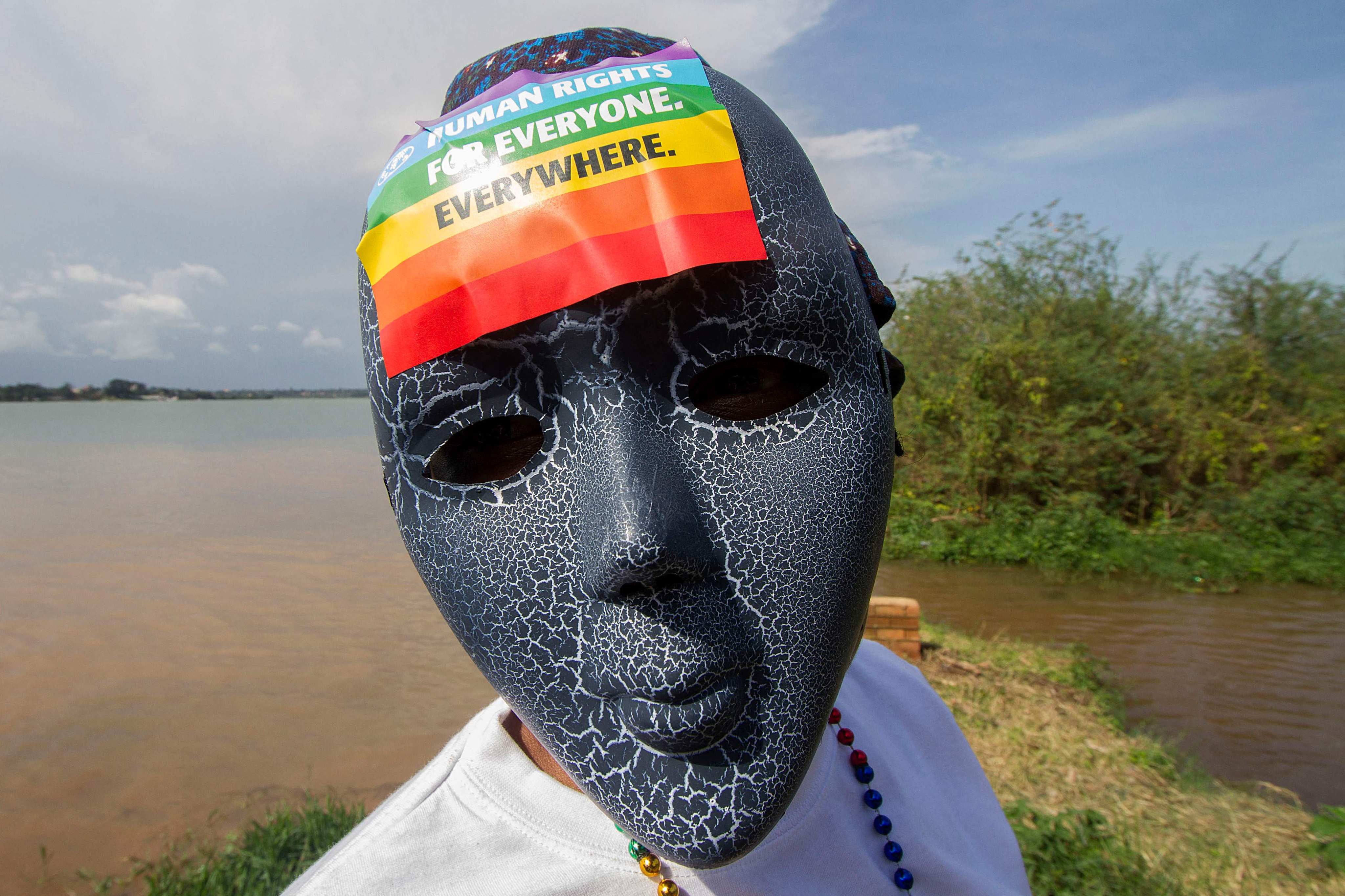 (FILES) A Ugandan wearing a mask with a rainbow sticker takes part in the Gay Pride parade in Entebbe on August 8, 2015. Uganda’s Constitutional Court on Wednesday rejected a bid to overturn a controversial anti-gay law that is considered one of the toughest in the world. Photo: AFP