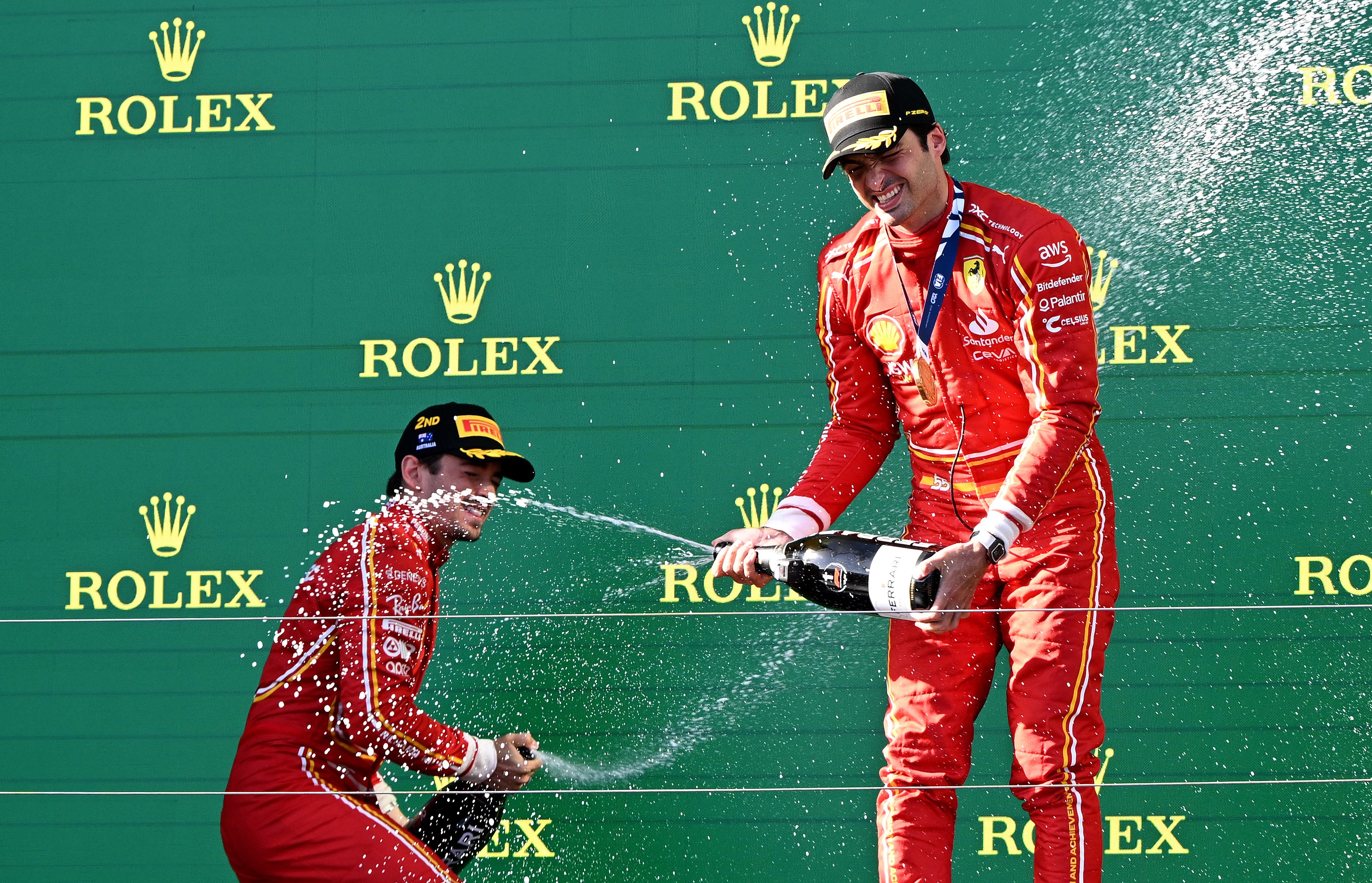 Ferrari drivers Charles Leclerc (left) and Carlos Sainz celebrate on the podium after the Australian Grand Prix. Photo: DPA