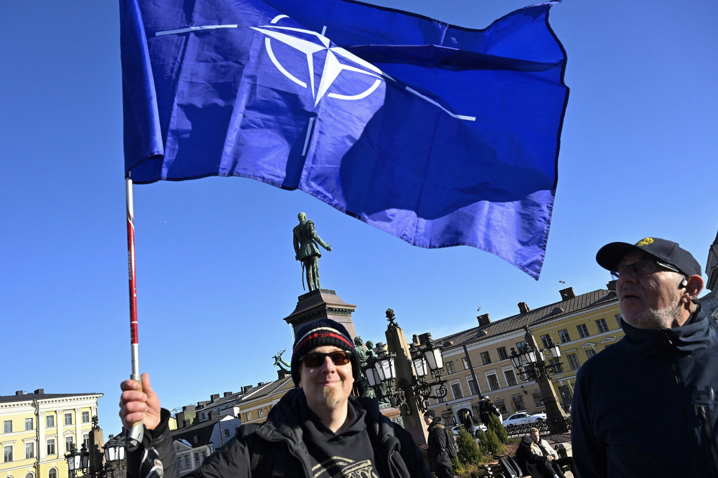 Celebrants wave the Nato flag at Senate Square in Helsinki on April 4, 2023, after Finland became the 31st country to join the transatlantic security alliance. Photo: AFP